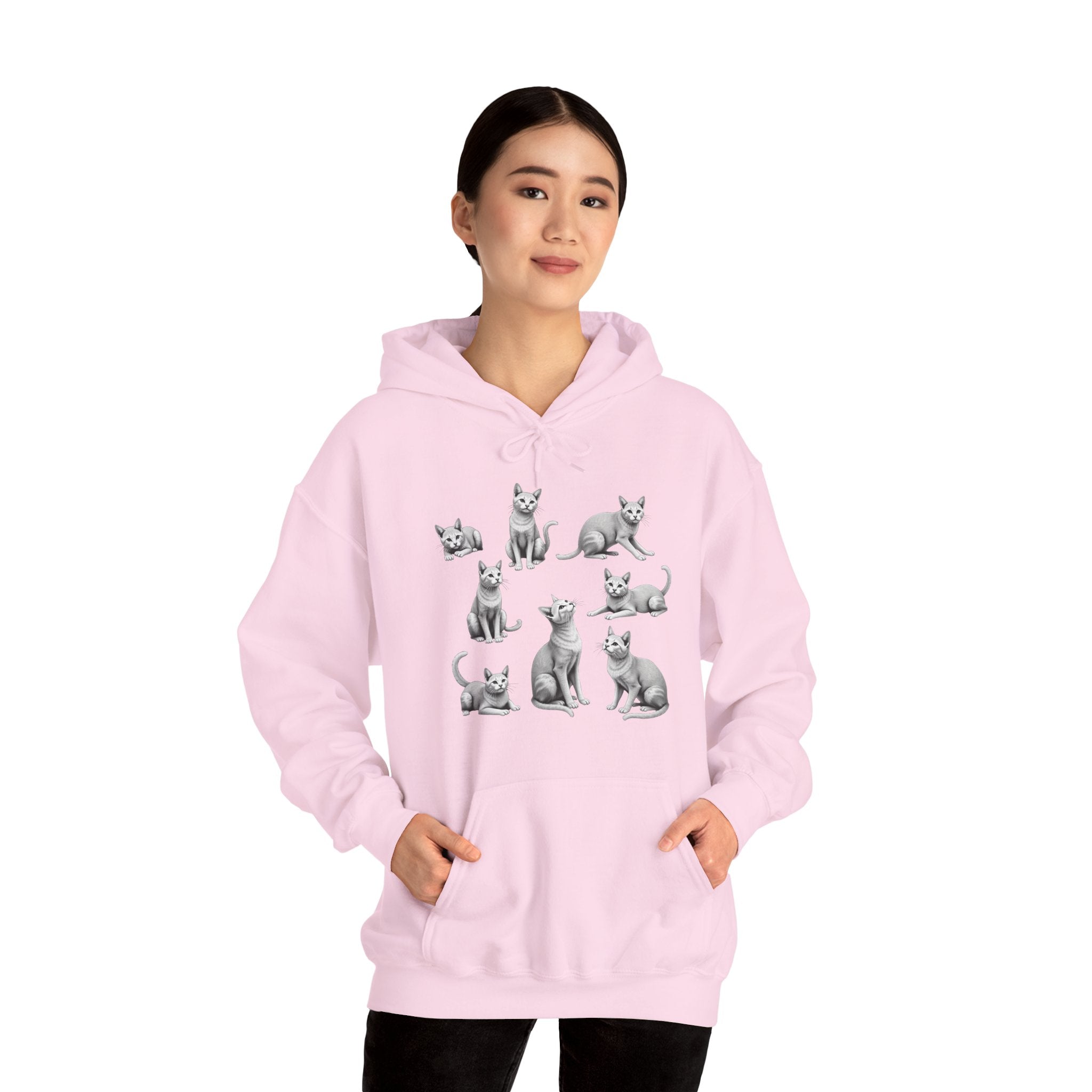 Person wearing a pink hoodie with cat illustrations on a white background