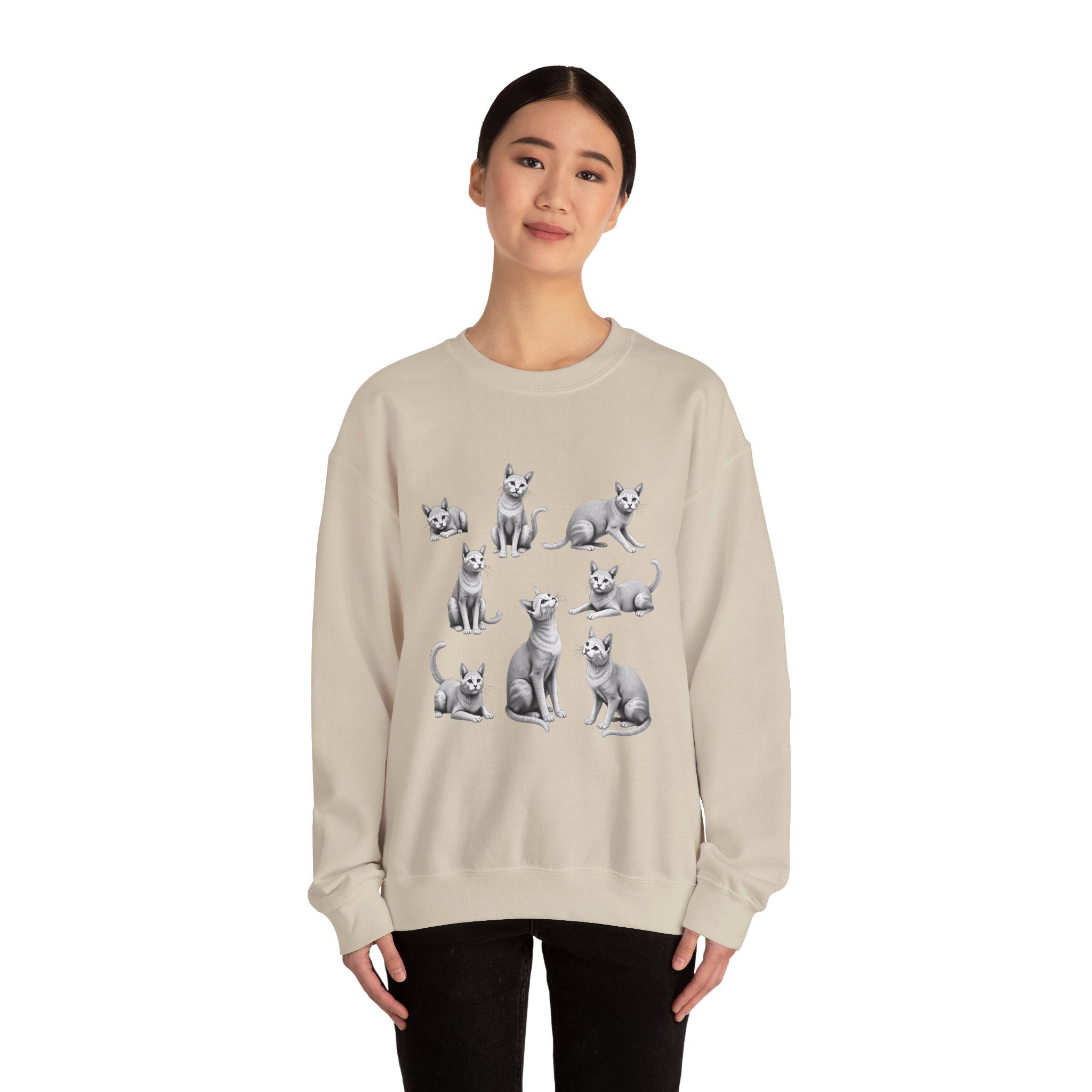 Person wearing a beige sweatshirt with dog illustrations on a white background