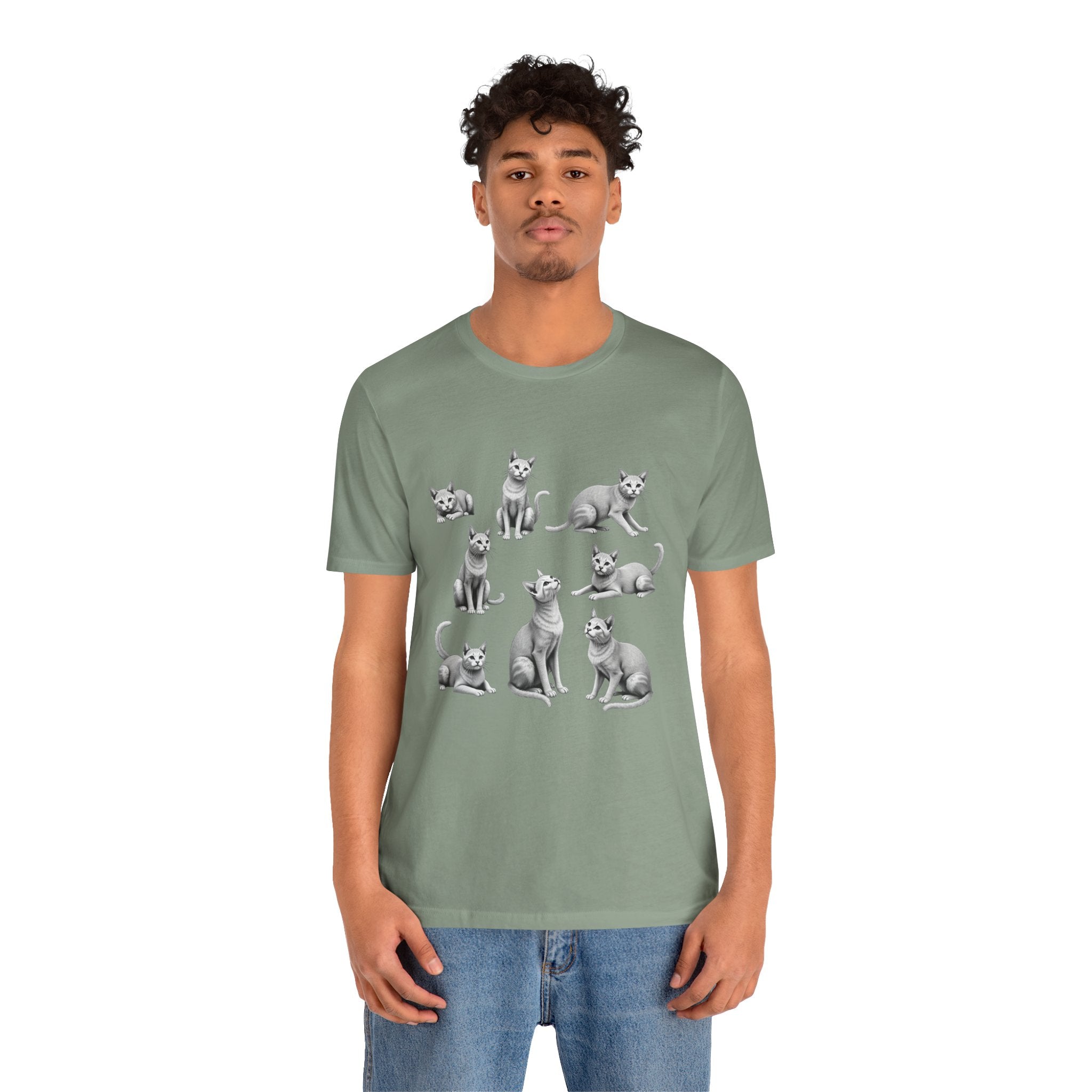 Person wearing a green t-shirt with cat illustrations on a white background