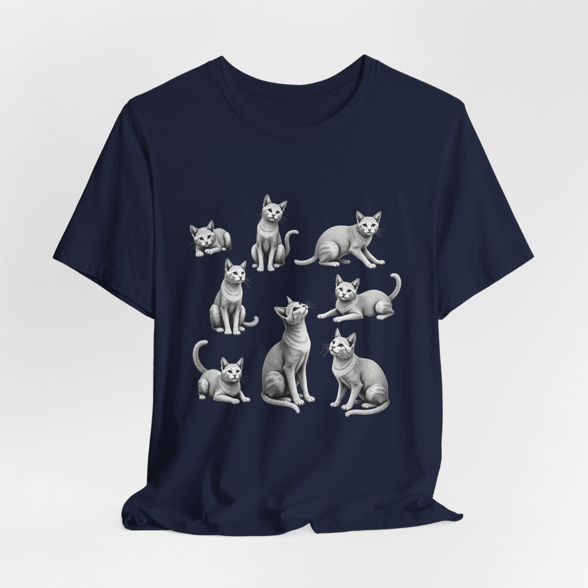 Navy blue t-shirt with white cat illustrations on a light gray background