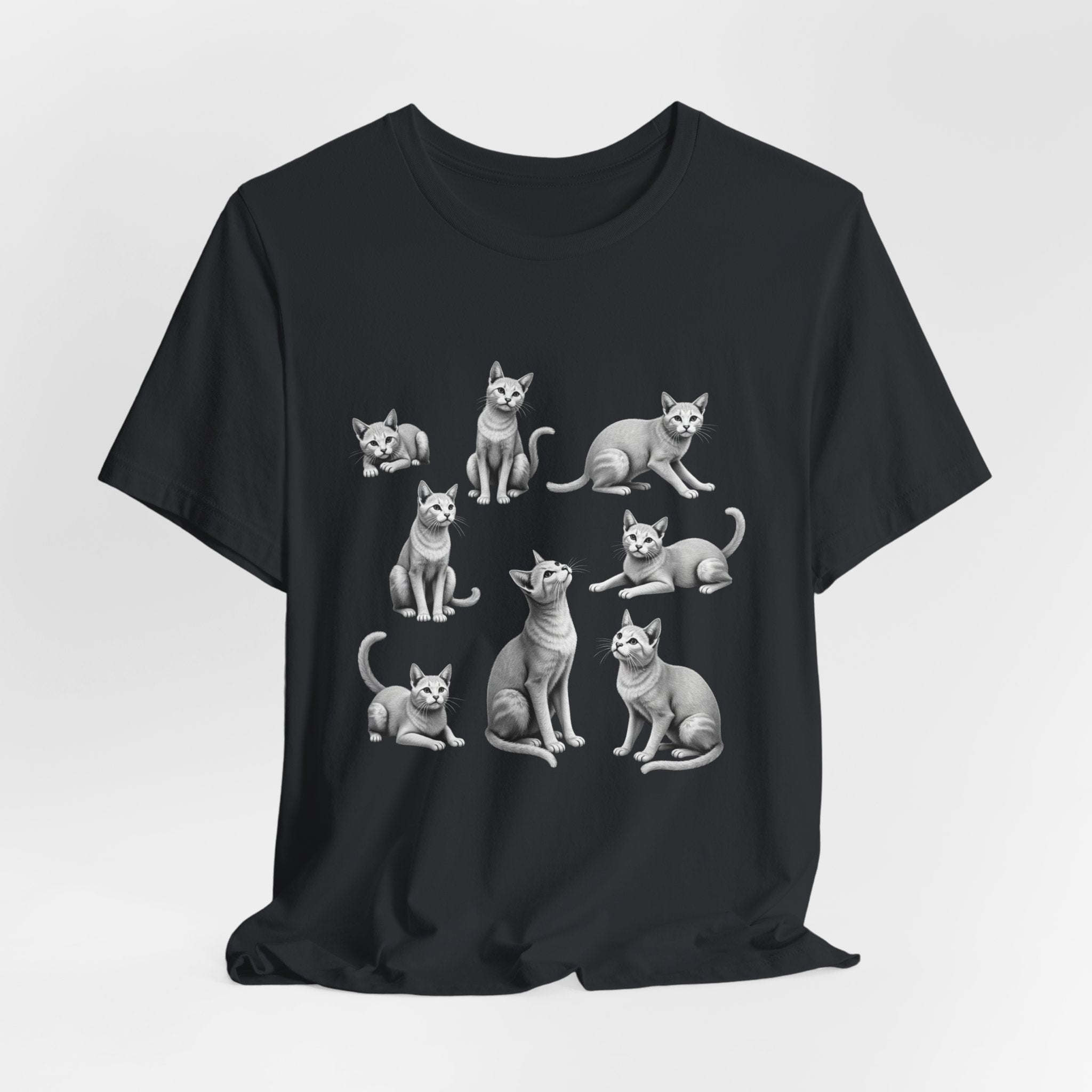 Vintage black t-shirt with white cat illustrations on a light gray background