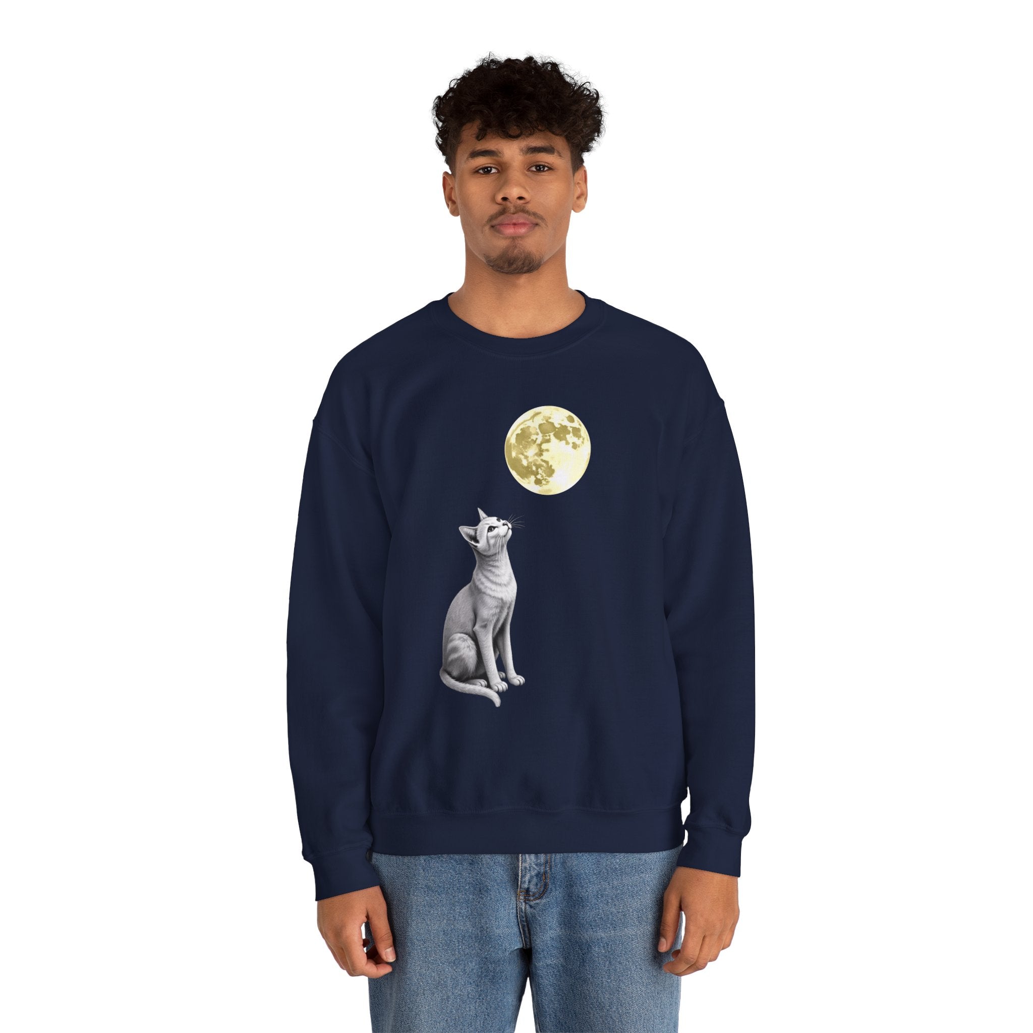 Person wearing a navy blue sweatshirt with a cat and moon design on a white background