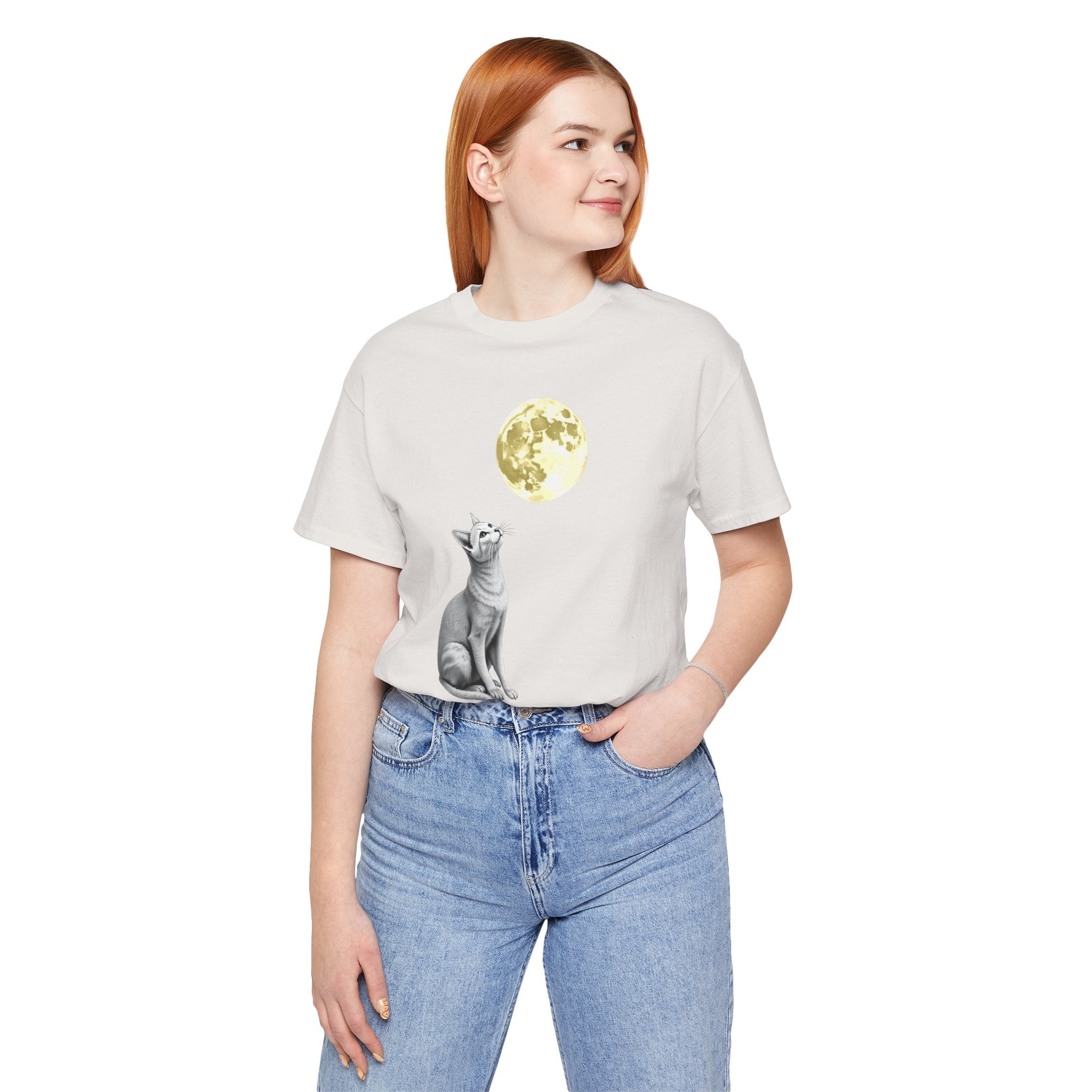 Person wearing a t-shirt with a graphic design of a bear and moon on a white background