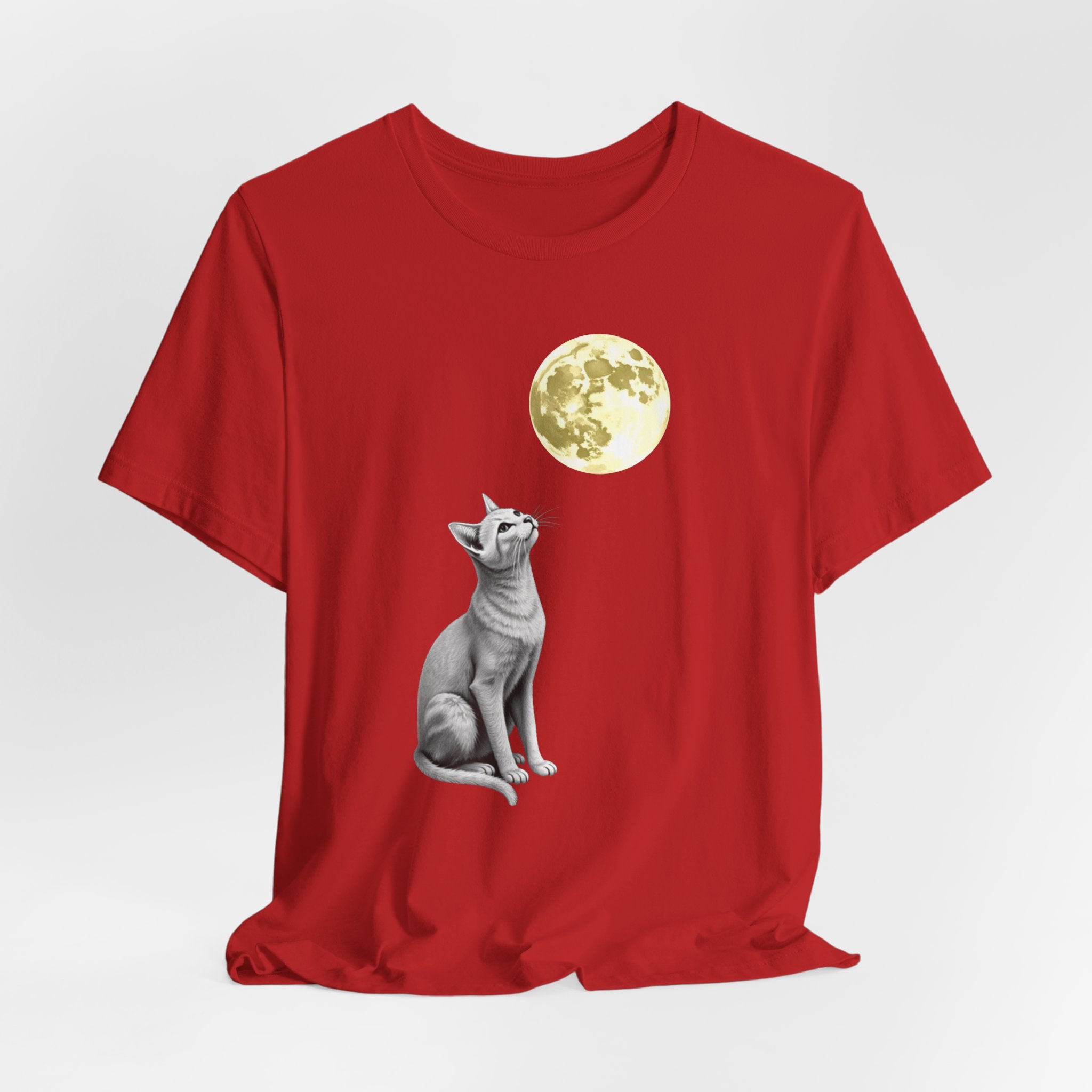 Red t-shirt with a cat and moon graphic on a white background