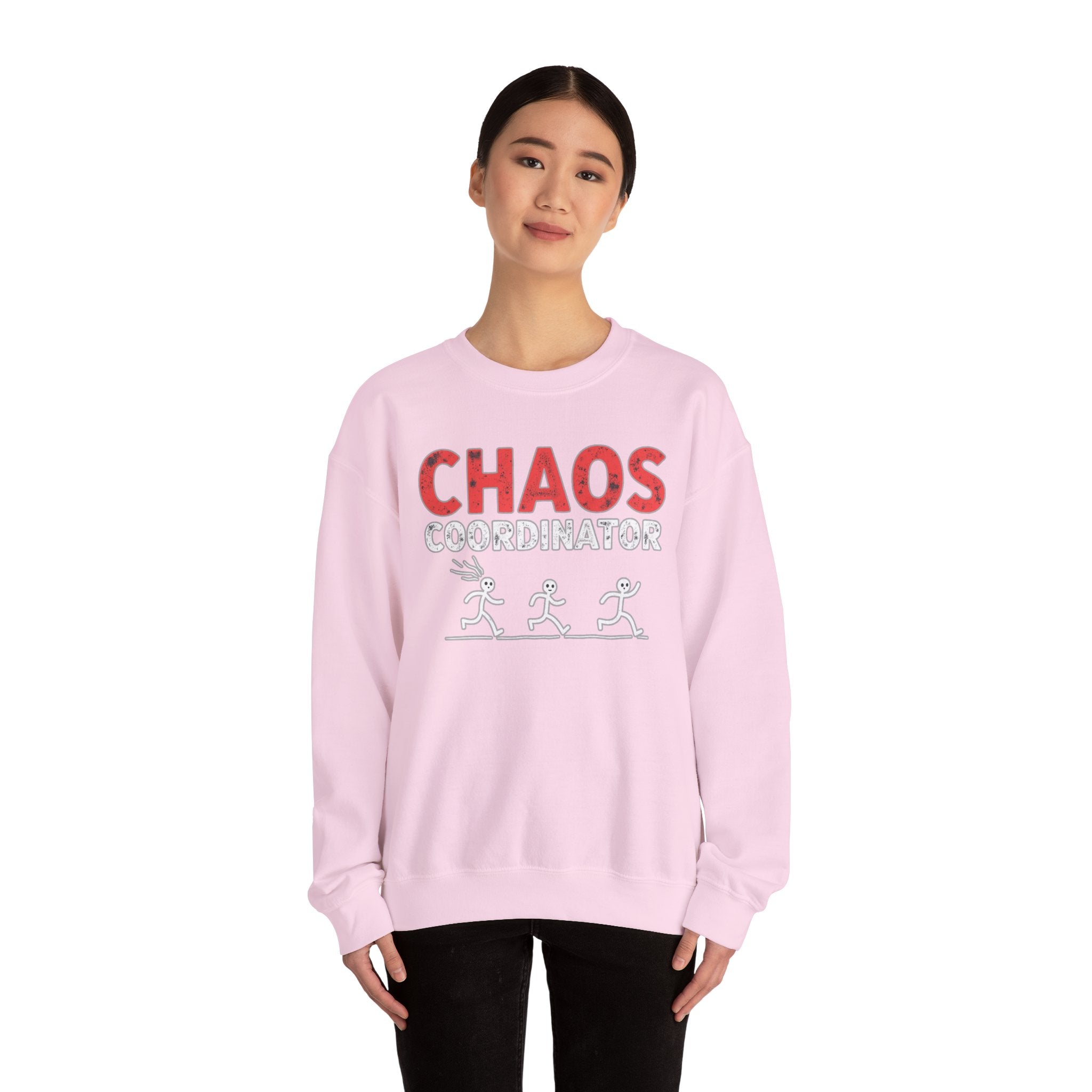 Person wearing a pink sweatshirt with 'CHAOS COORDINATOR' text on a white background