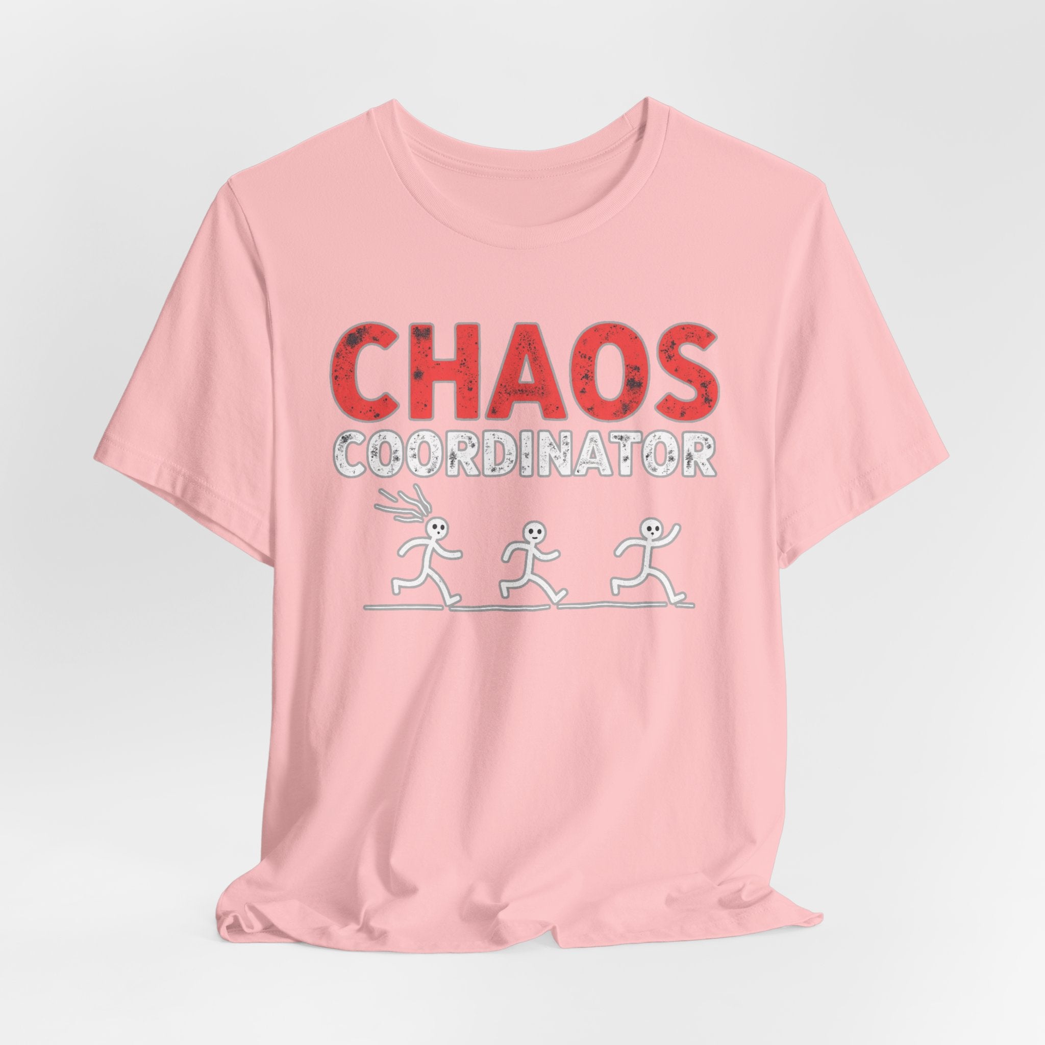 Pink t-shirt with 'CHAOS COORDINATOR' text and stick figure graphics on a light gray background