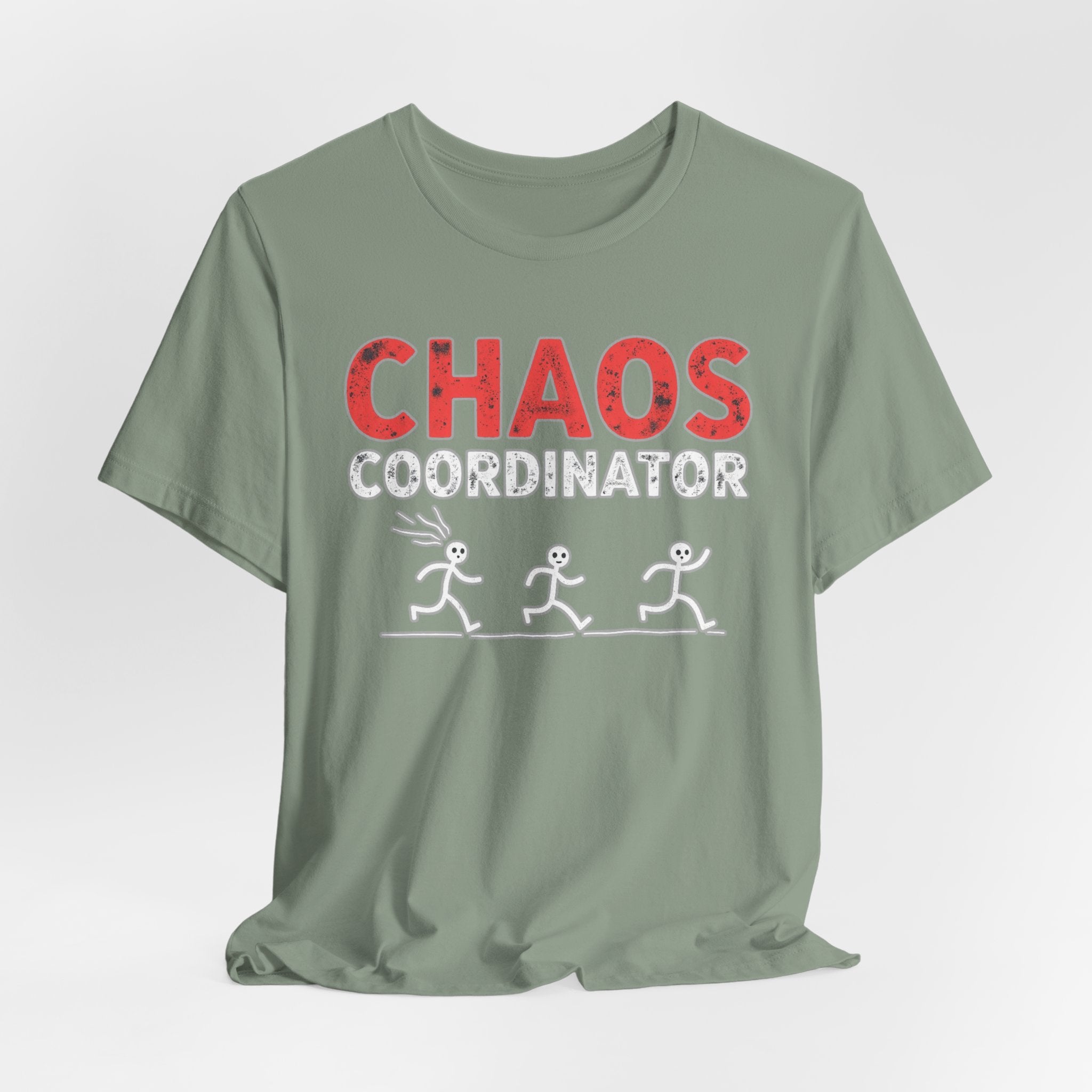 Sage green t-shirt with 'CHAOS COORDINATOR' text and stick figure graphic on a white background