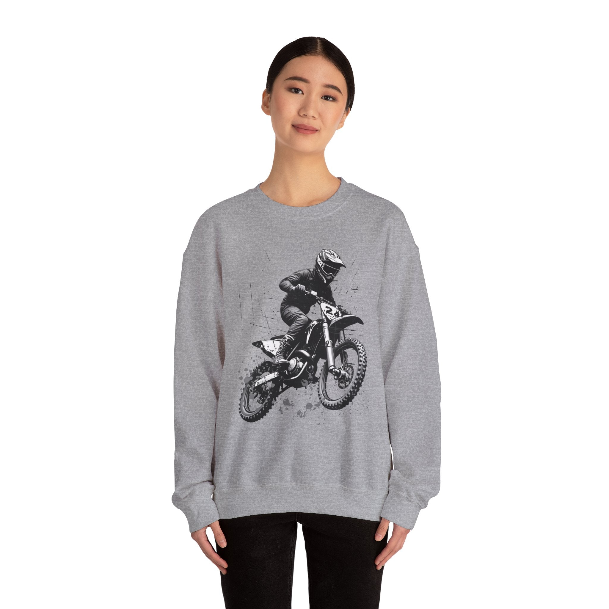 Person wearing a gray sweatshirt with a graphic of a person on a motorcycle
