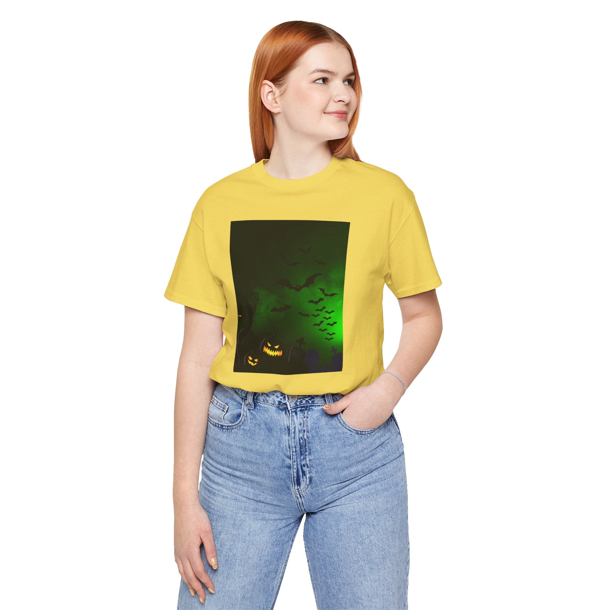 Person wearing a yellow t-shirt with a graphic design on a white background
