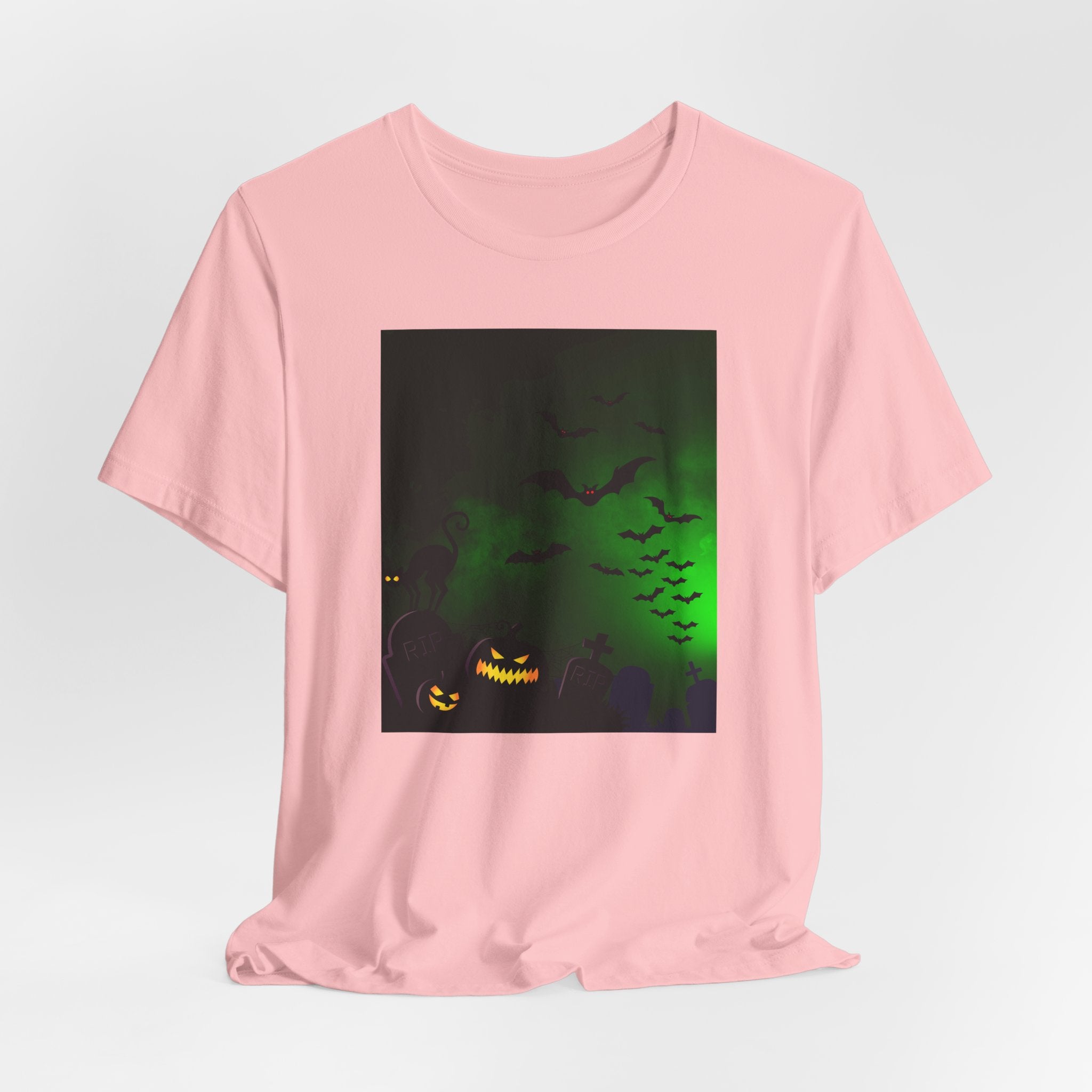 Pink t-shirt with a Halloween-themed graphic on a light gray background