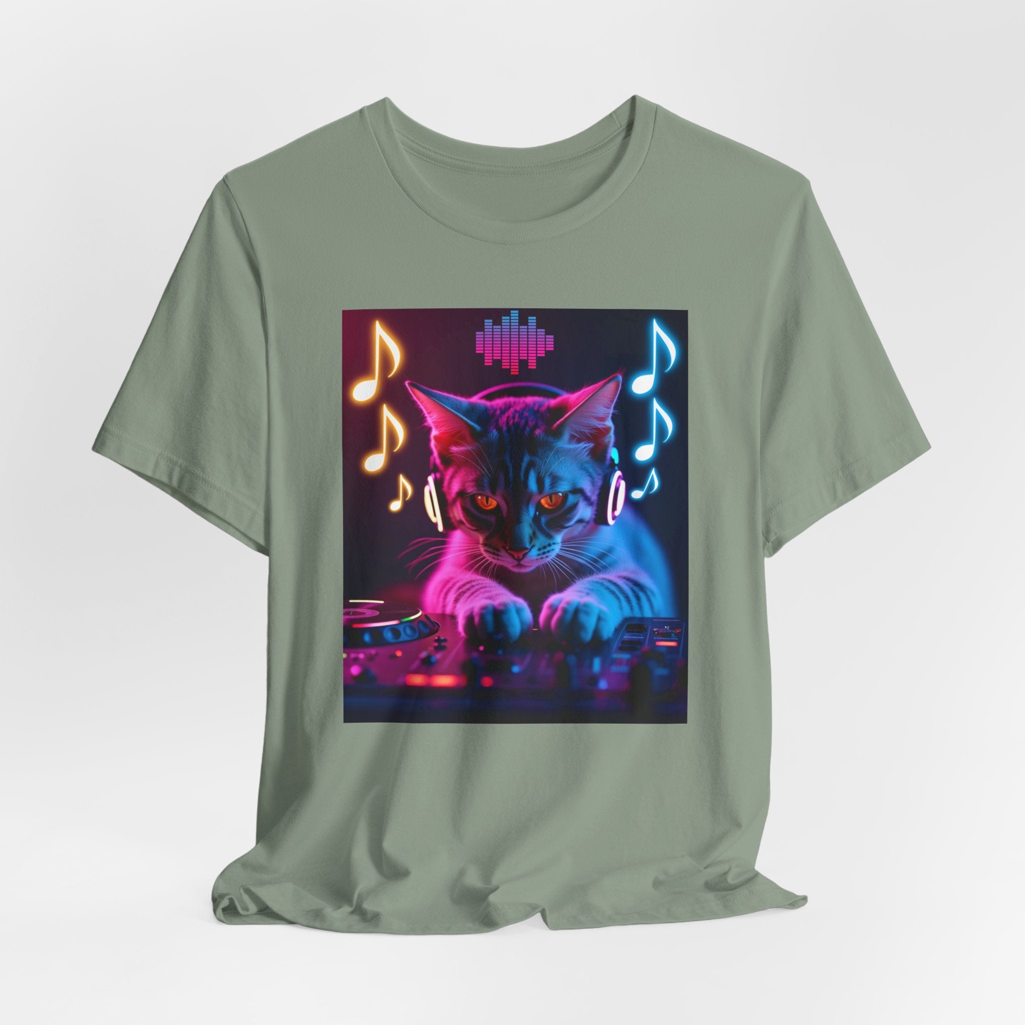 Sage green t-shirt with a cat playing DJ equipment graphic with music notes and sound waves on a white background