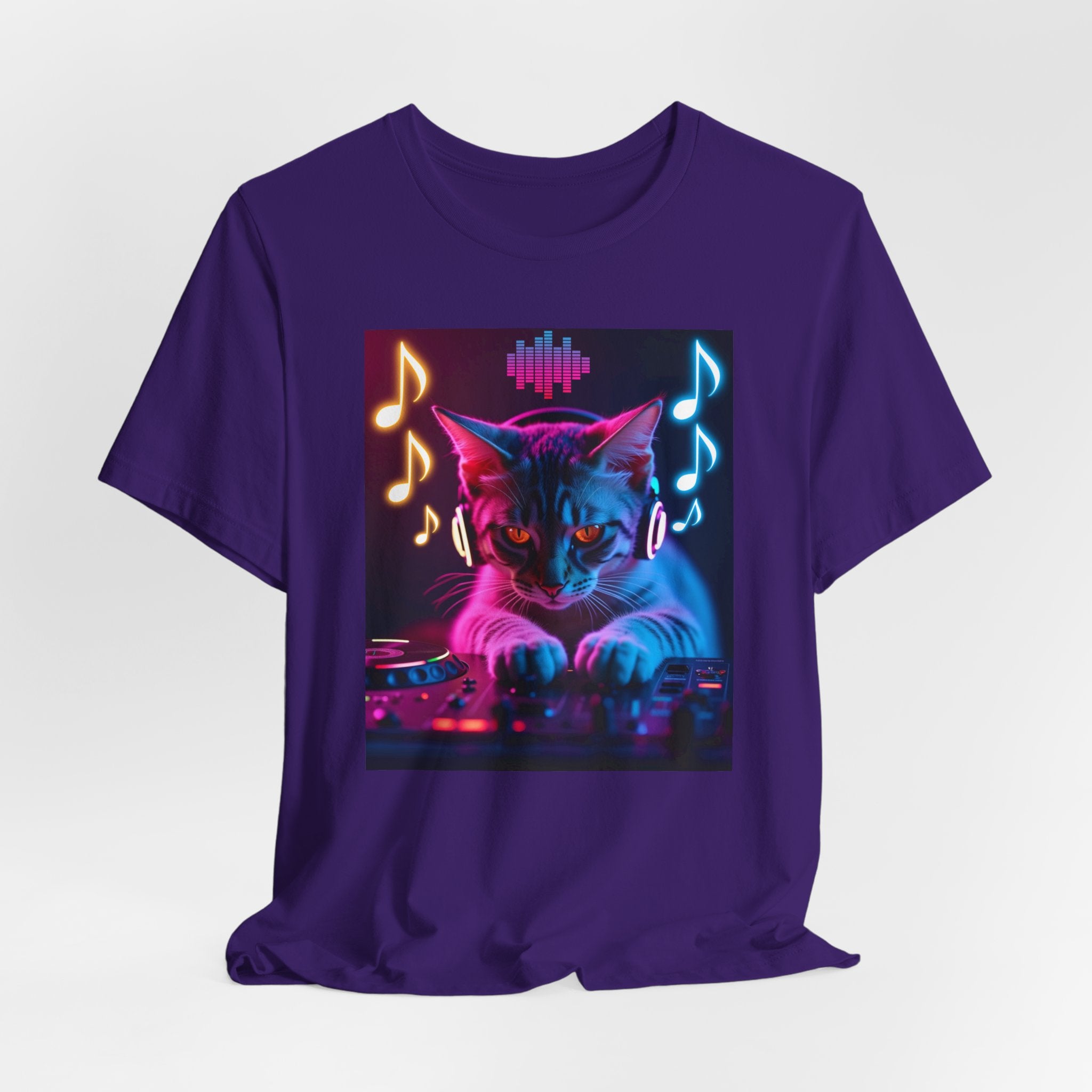 Team purple t-shirt with a cat playing DJ equipment graphic with music notes and sound waves on a white background