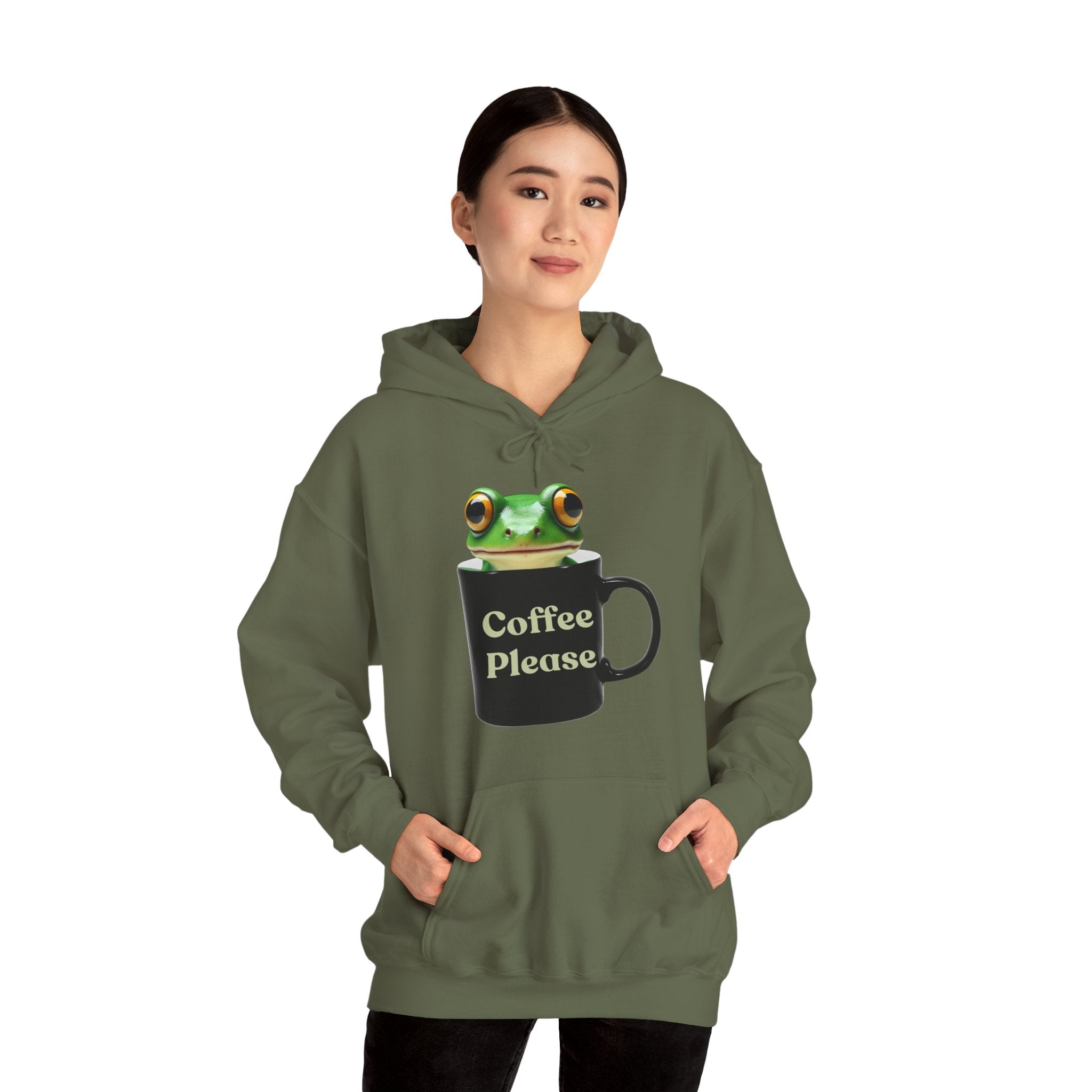 Person wearing a green hoodie with a frog inside the cup and a text "coffee please" on a white background