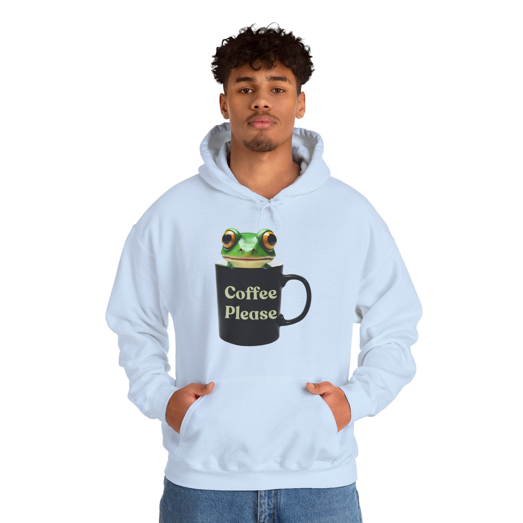 Person wearing a light blue hoodie with a frog inside the cup and a text "coffee please" on a white background