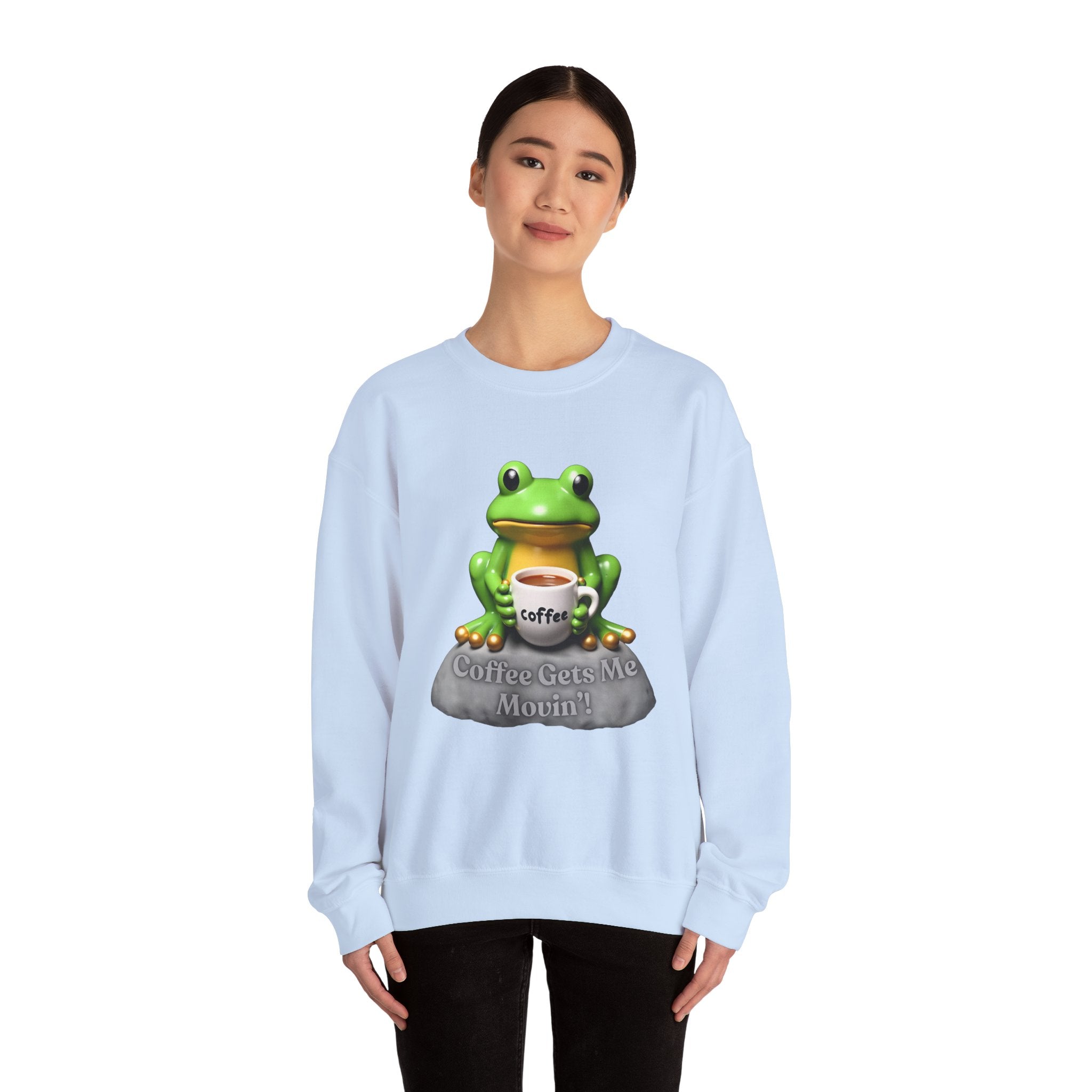 Light blue sweatshirt with a frog graphic and text worn by a person on a white background