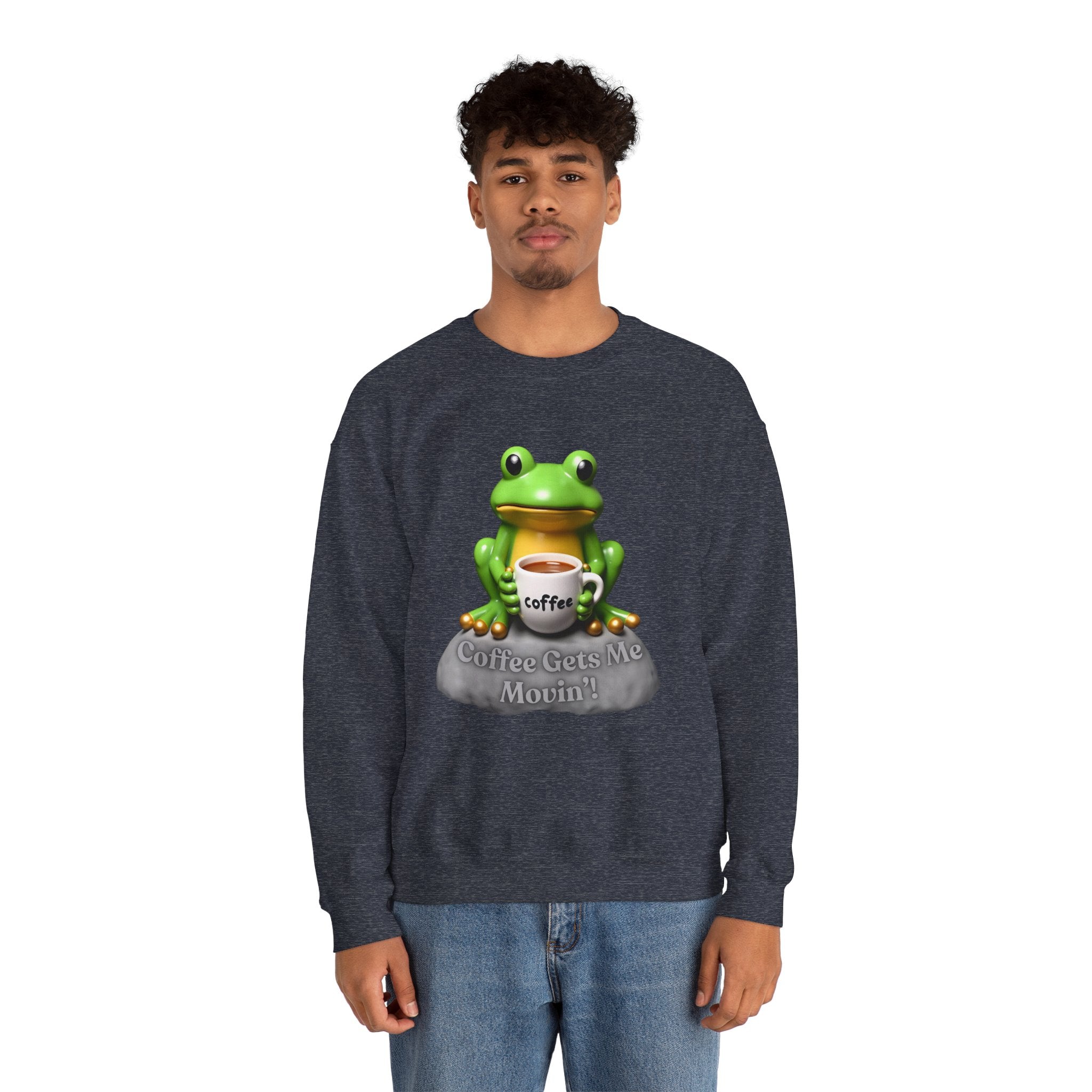 Person wearing a dark blue sweatshirt with a frog graphic holding a coffee cup on a white background