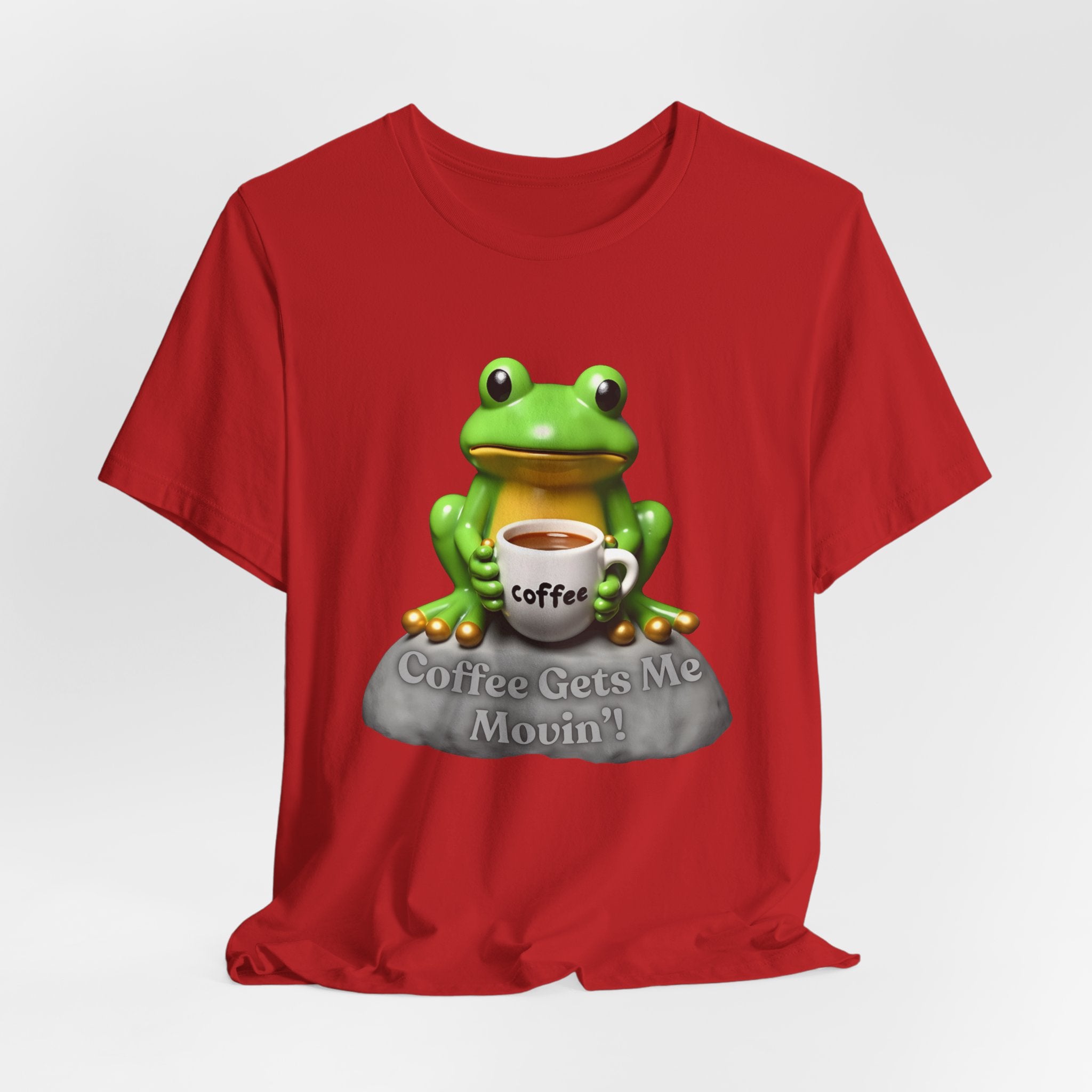 Red t-shirt with a green frog holding a coffee cup and 'Coffee Gets Me Movin'' text on a white background