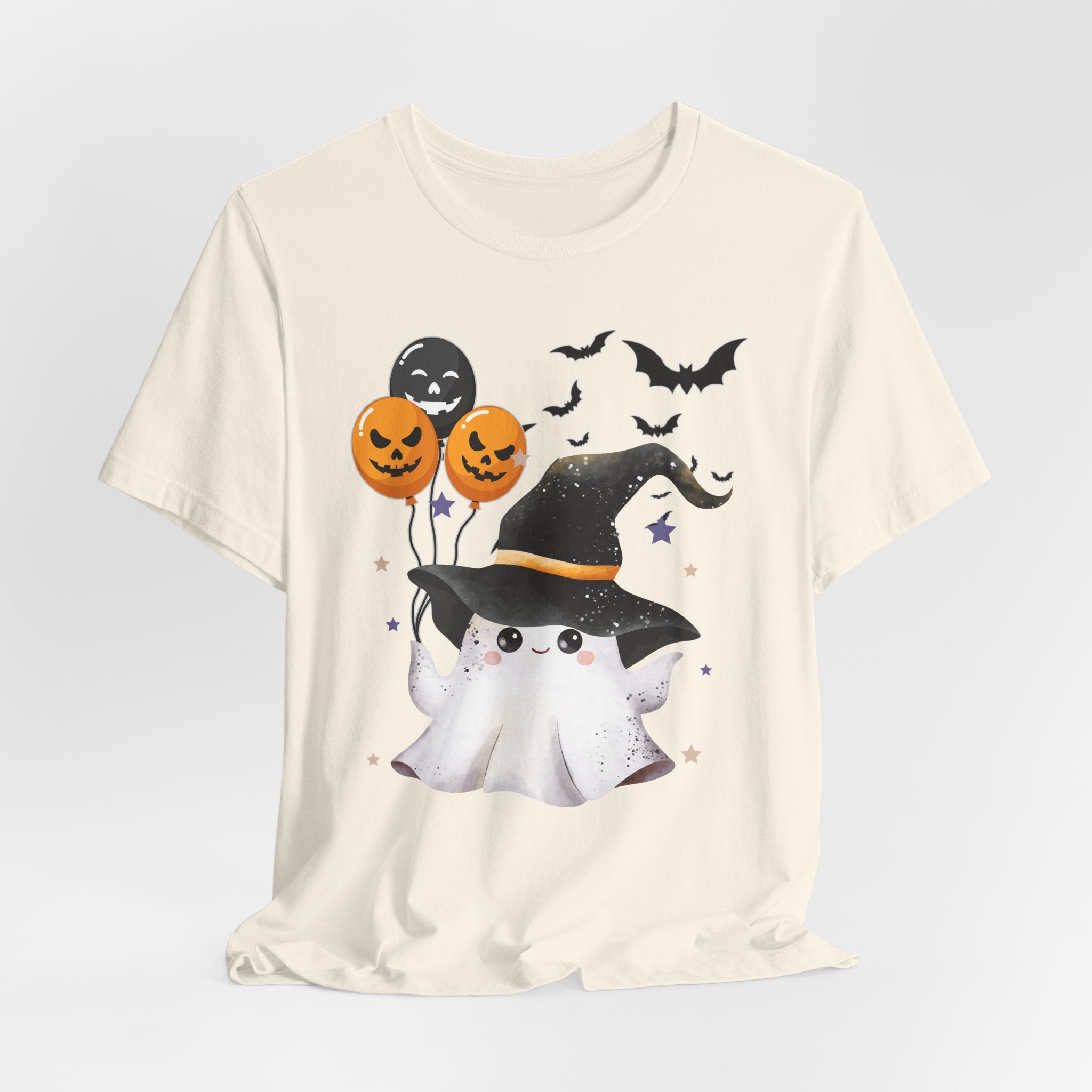 Ivory beige t-shirt with Halloween-themed design featuring a ghost, pumpkins, and bats on a light gray background.