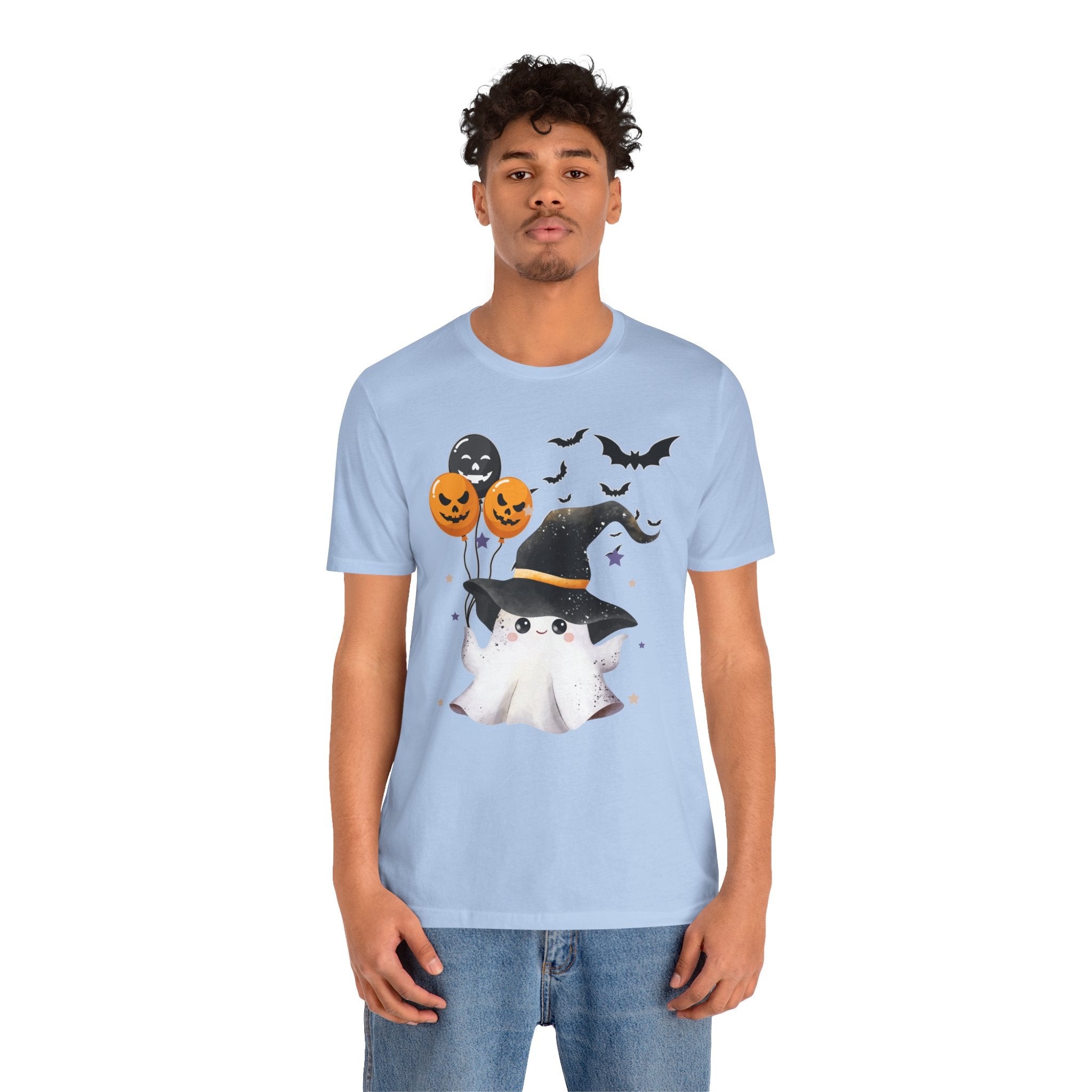 Person wearing a light blue t-shirt with Halloween-themed design on a white background