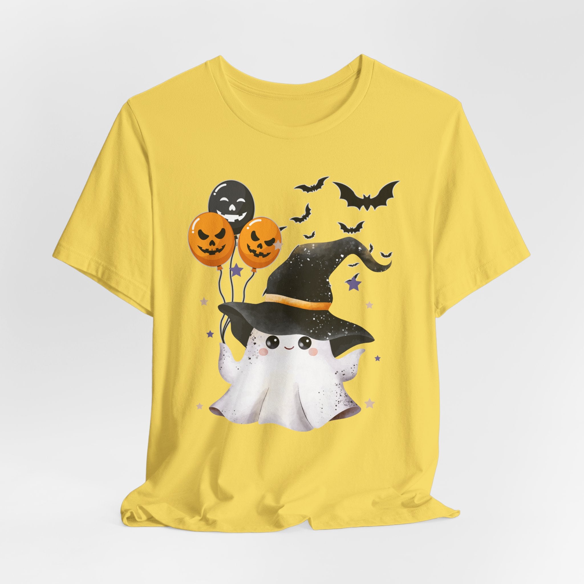 Yellow t-shirt with Halloween-themed design featuring a ghost, pumpkins, and bats on a white background.