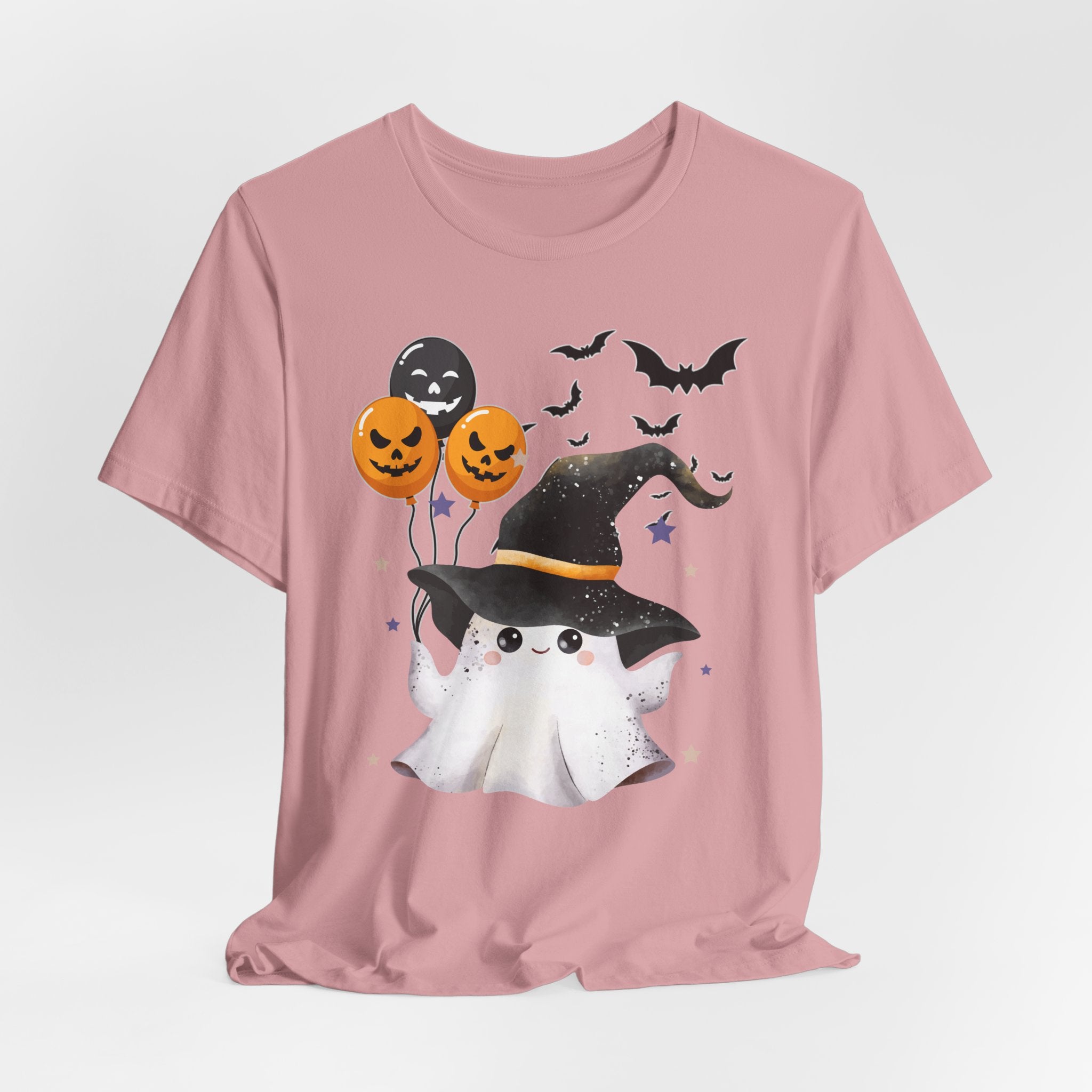 Orchid pink t-shirt with Halloween-themed design featuring a ghost, witch hat, and balloons on a light gray background.