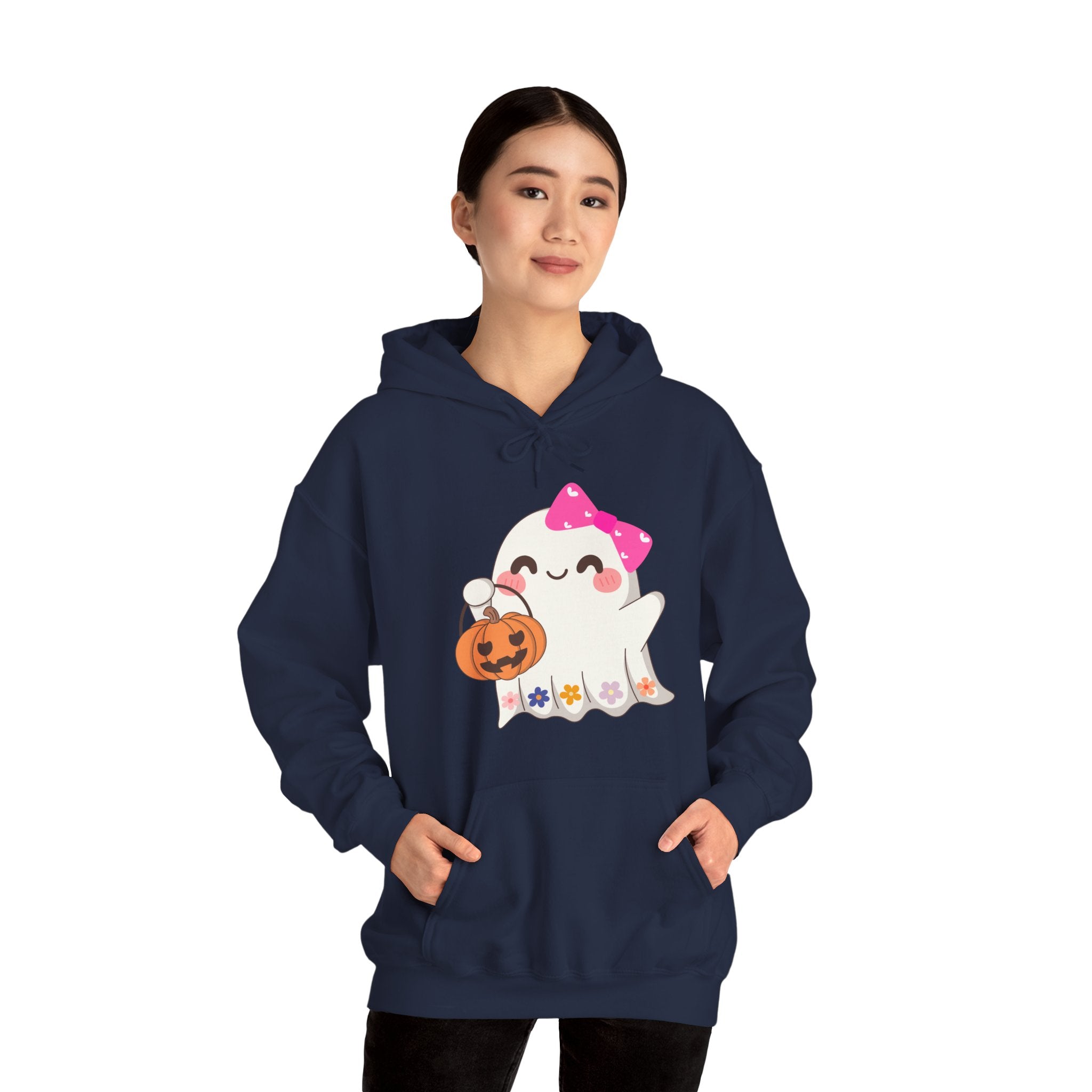 Person wearing a navy blue hoodie with a ghost holding a pumpkin design on a white background