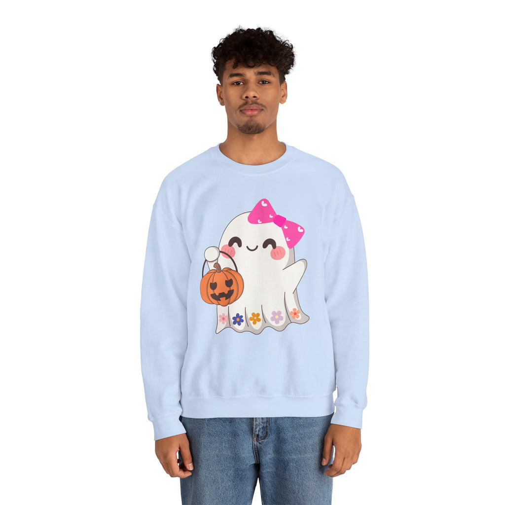 Person wearing a light blue sweatshirt with a ghost and pumpkin design on a white background