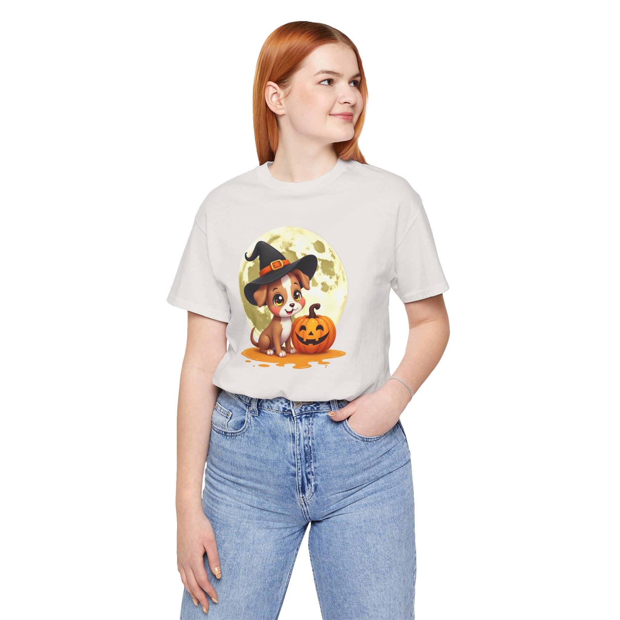 Person wearing a white t-shirt with a Halloween-themed graphic of a dog in a witch hat and pumpkin.