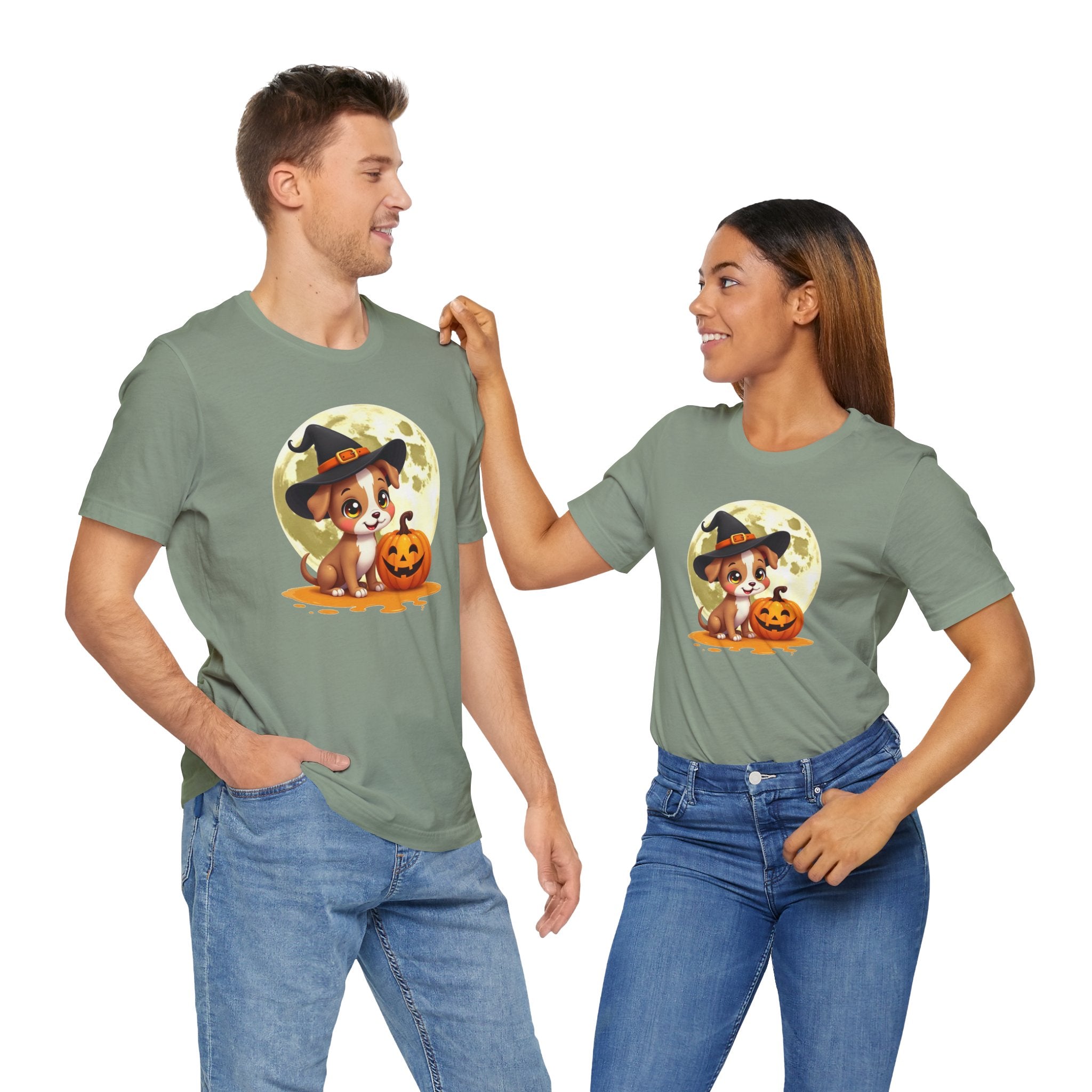 Two people wearing green t-shirts with a Halloween-themed design of a dog in a witch hat and pumpkin.