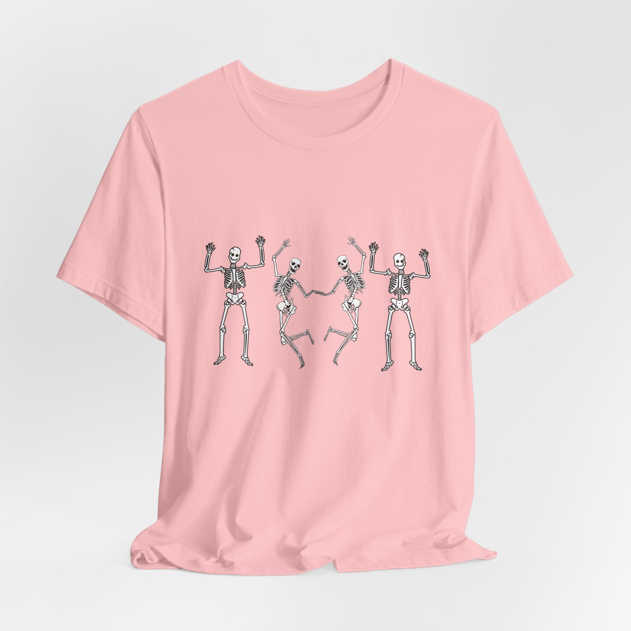 Pink t-shirt with skeleton designs on a light gray background
