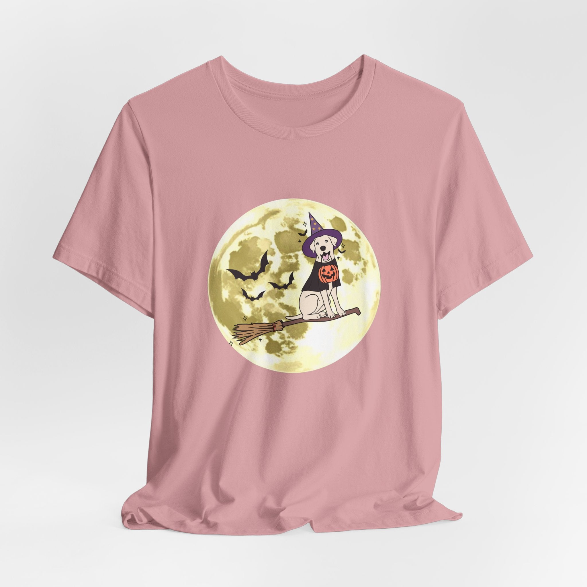 Orchid pink t-shirt with Halloween design featuring bats and a dog in a witch hat and pumpkin on a broomstick against a moonlit sky.