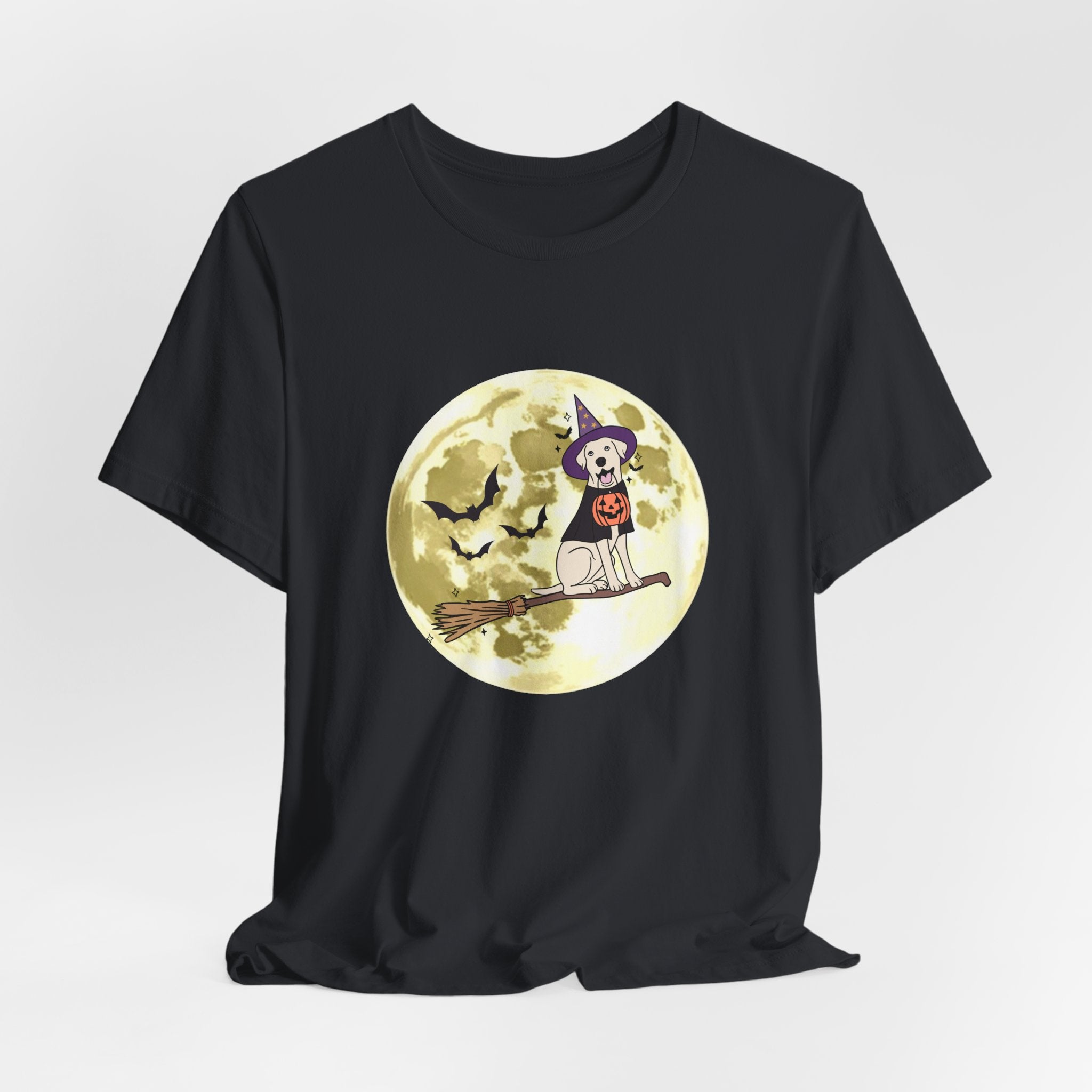 Vintage black t-shirt with Halloween design featuring bats and a dog in a witch hat and pumpkin on a broomstick against a moonlit sky.