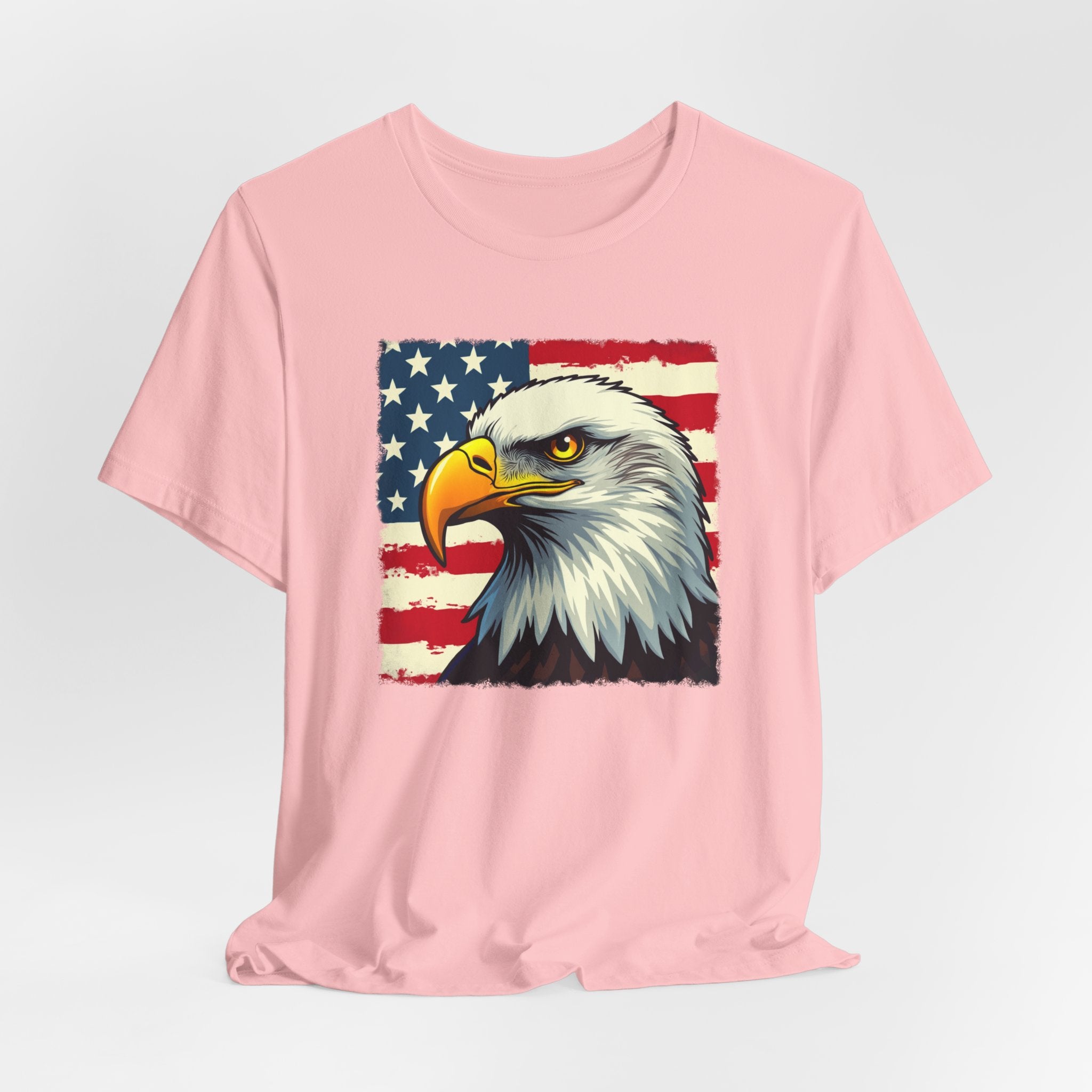 Pink t-shirt with an eagle and American flag design on a light gray background