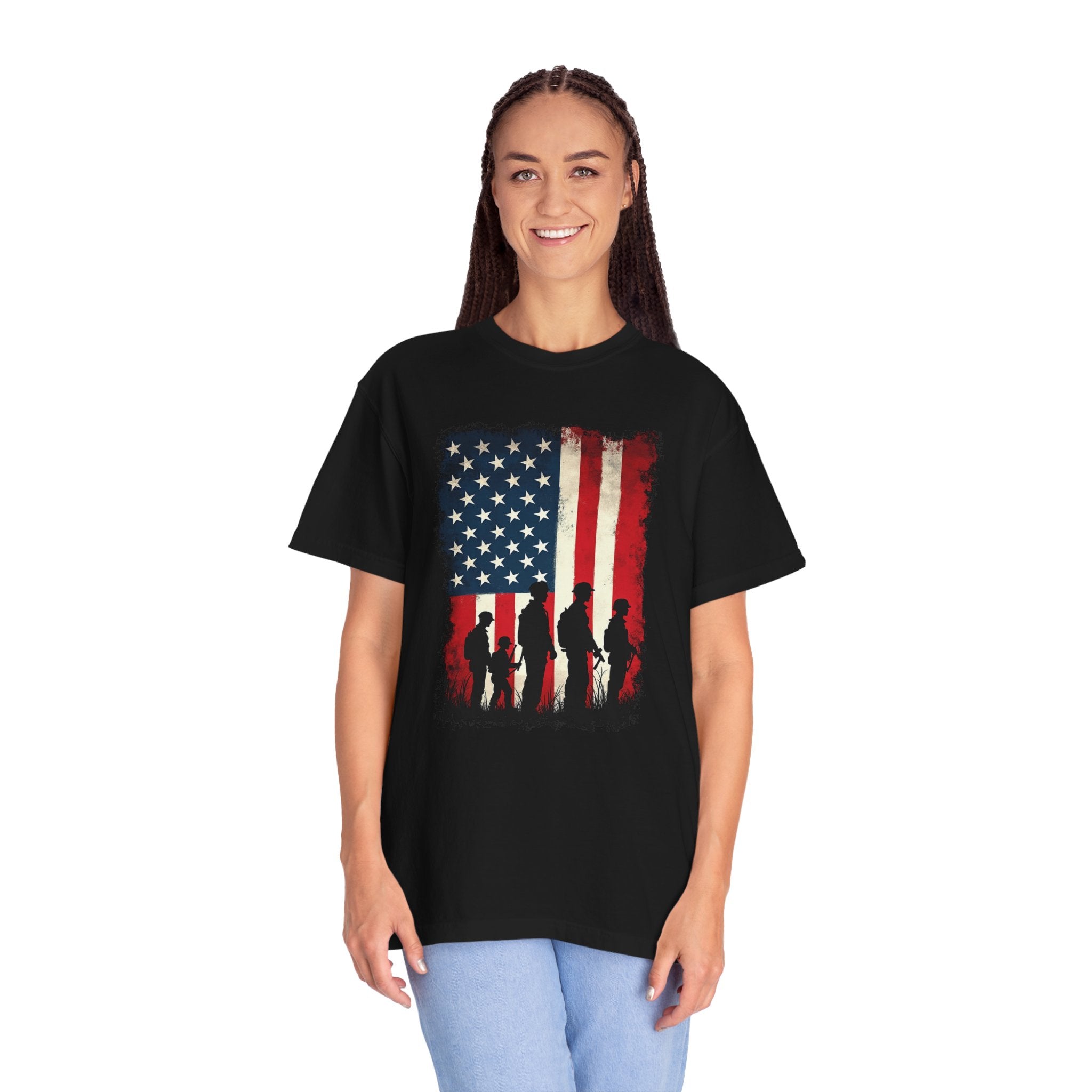 Person wearing a black t-shirt with an American flag design featuring silhouettes of soldiers.
