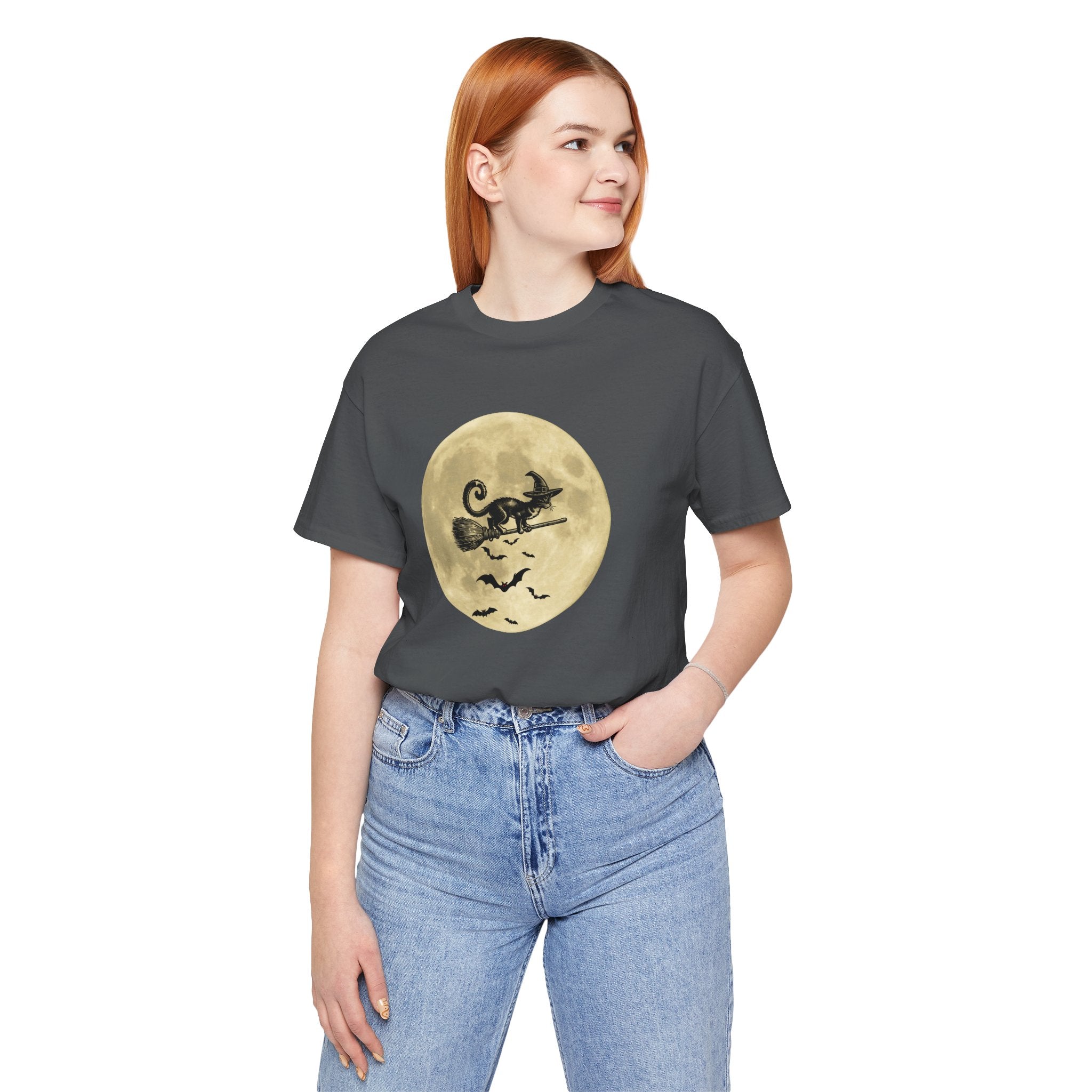 Person wearing a dark gray t-shirt with a full moon and cat graphic, standing against a white background.