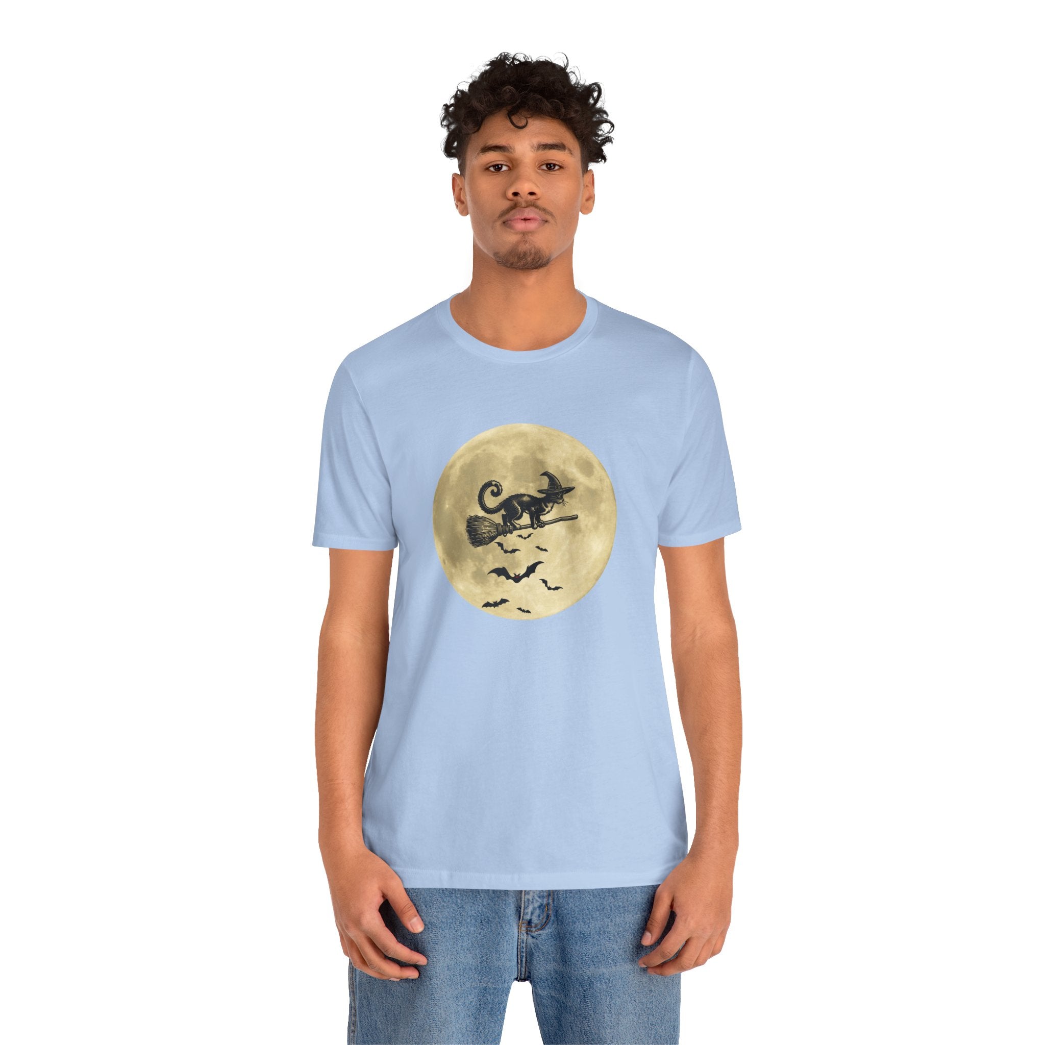 Person wearing a light blue t-shirt with a graphic design on a white background