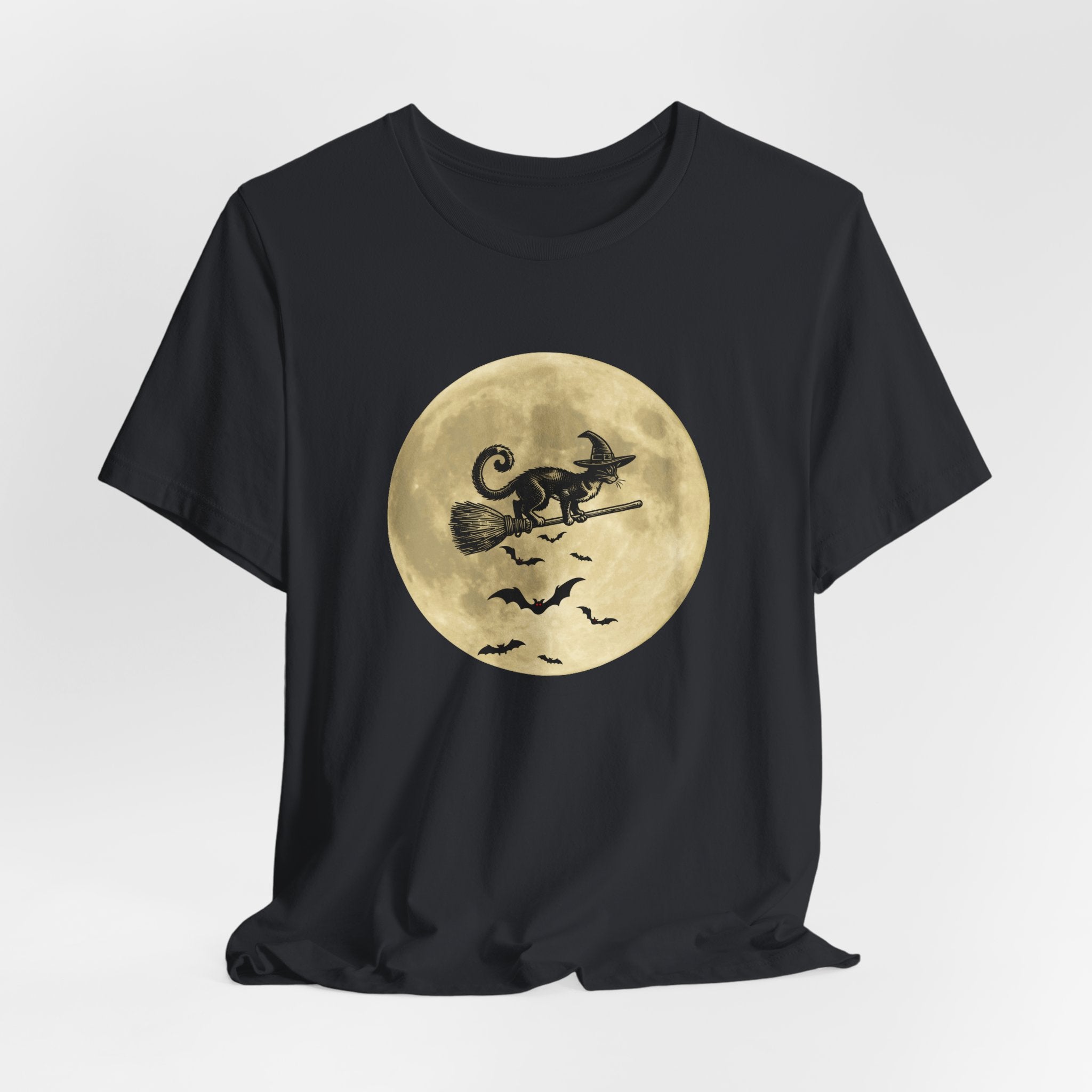 Vintage black t-shirt with a Halloween design of a cat on a broomstick against a full moon.