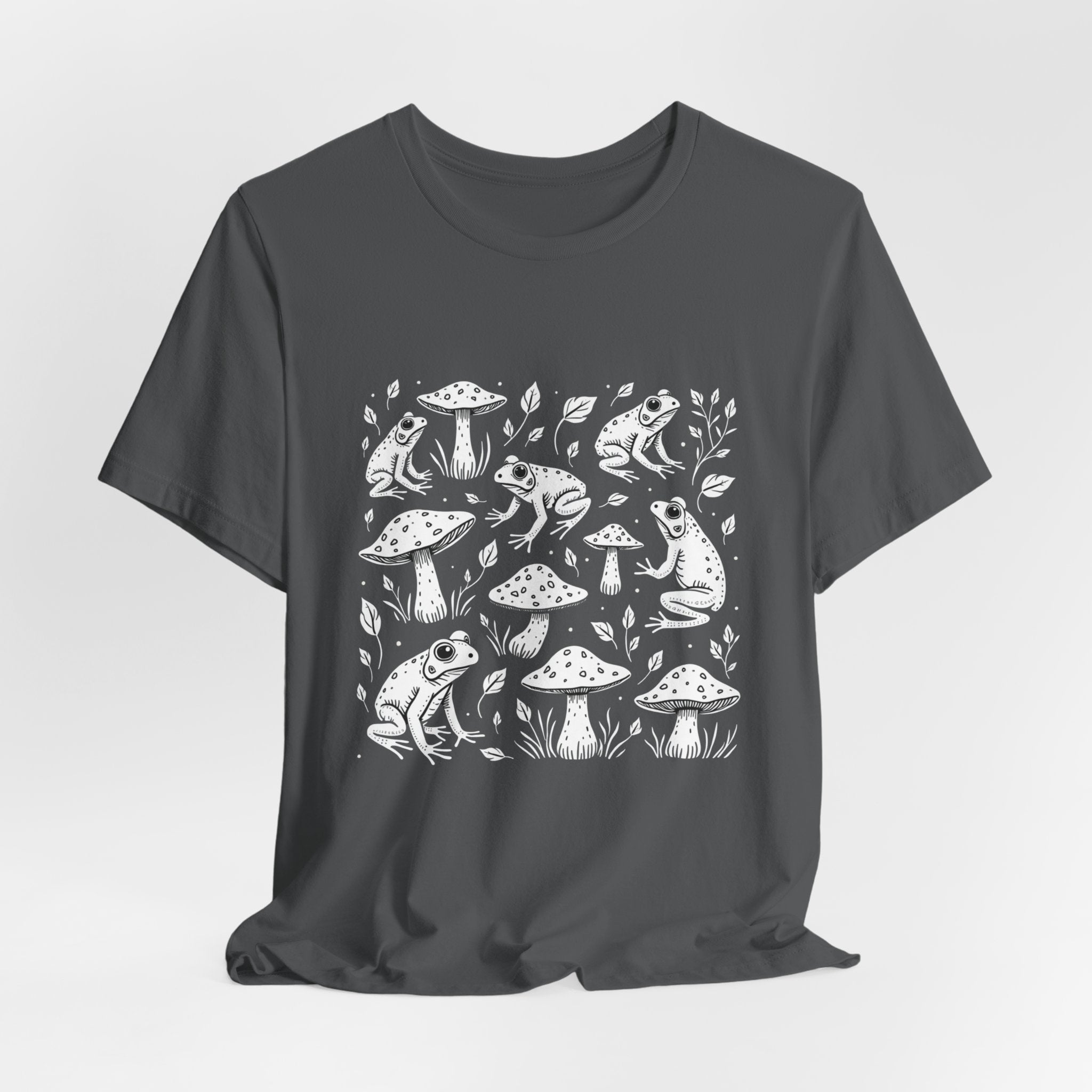 Asphalt gray t-shirt with white frogs, grass and mushroom design on a white background