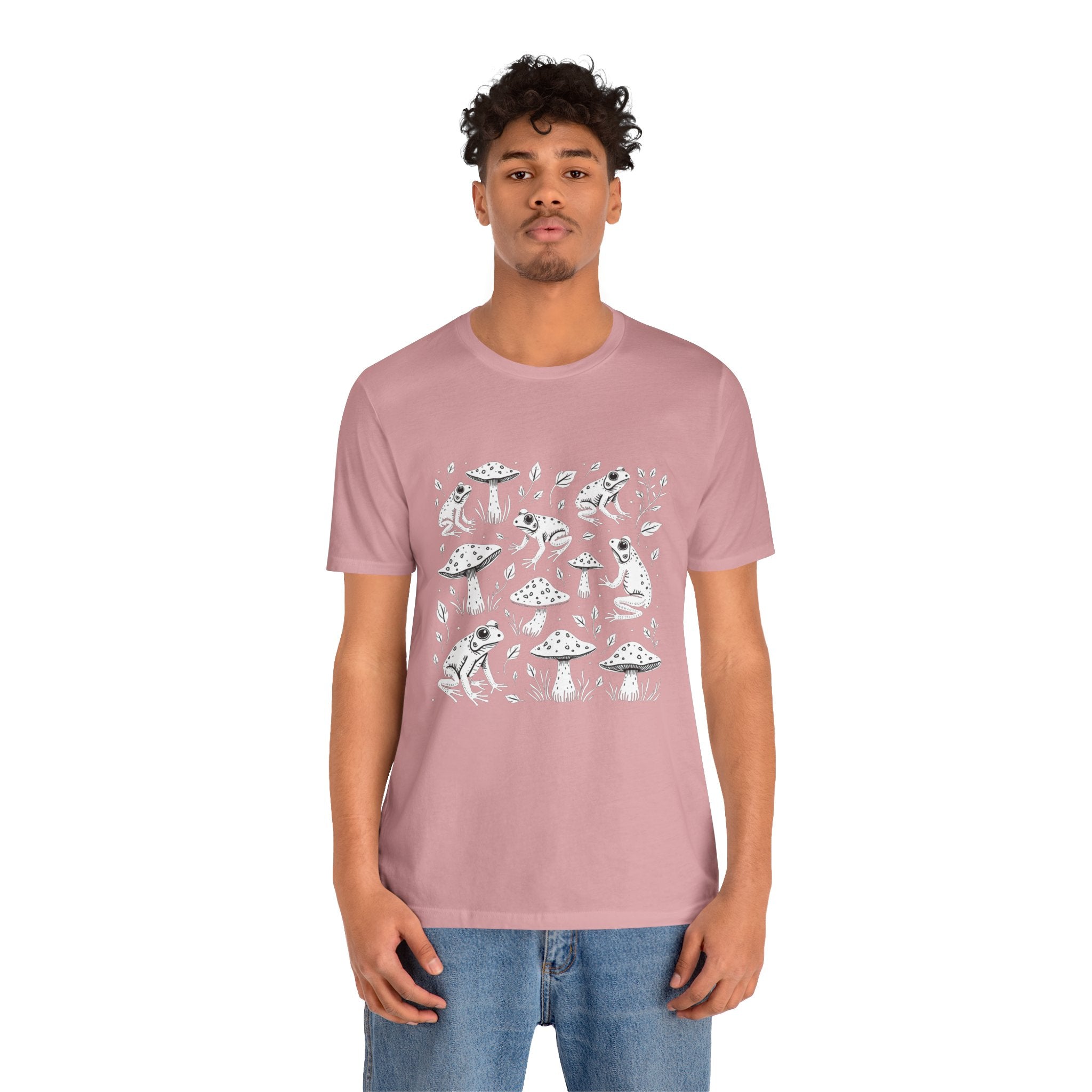 Person wearing a pink t-shirt with white graphics on a white background
