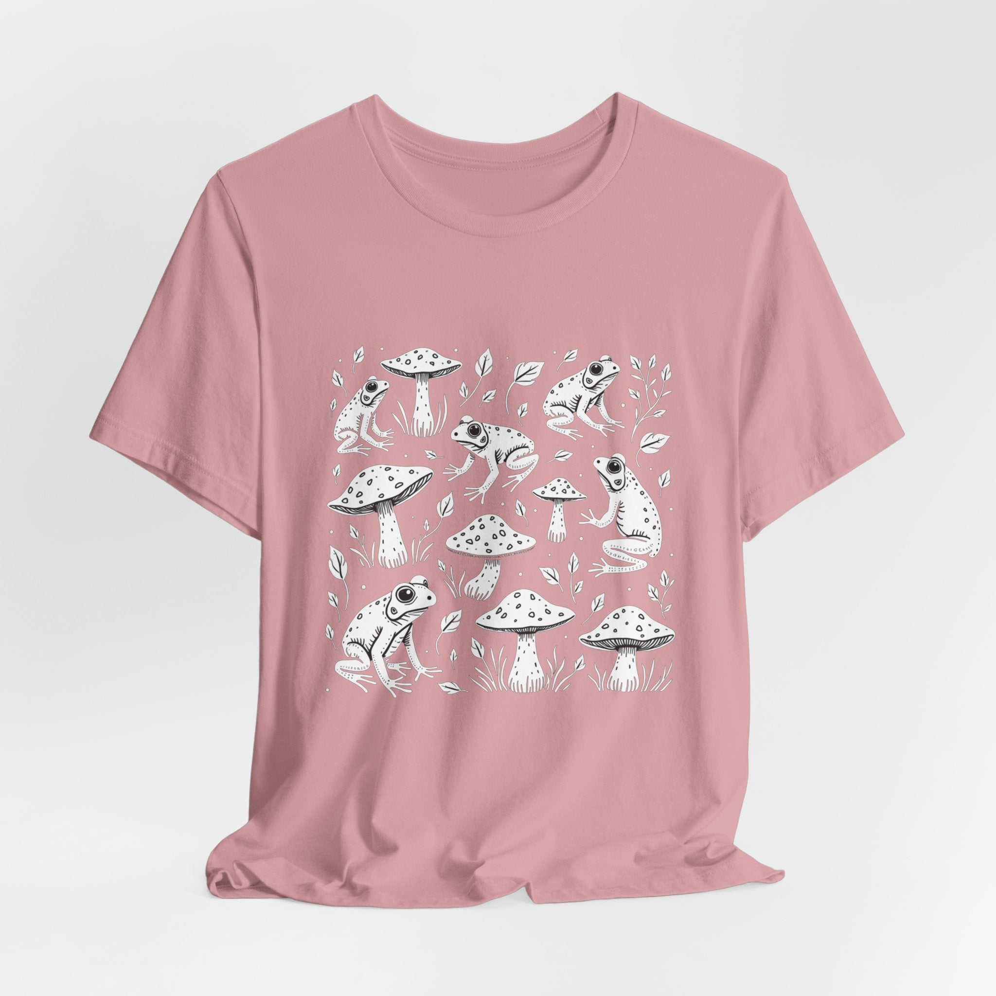 Orchid pink t-shirt with white frogs, grass and mushroom design on a white background