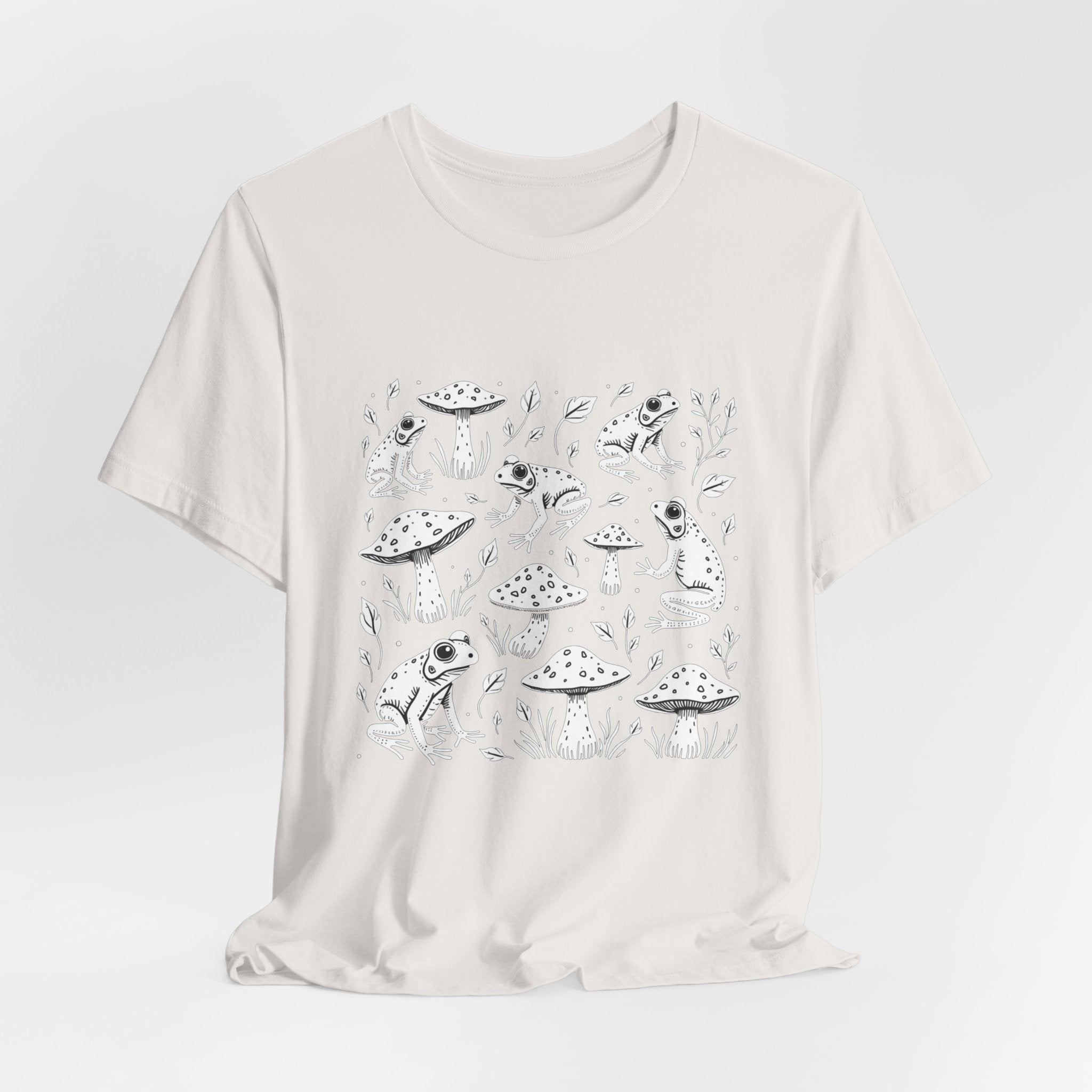 Vintage white t-shirt with white frogs, grass and mushroom design on a white background