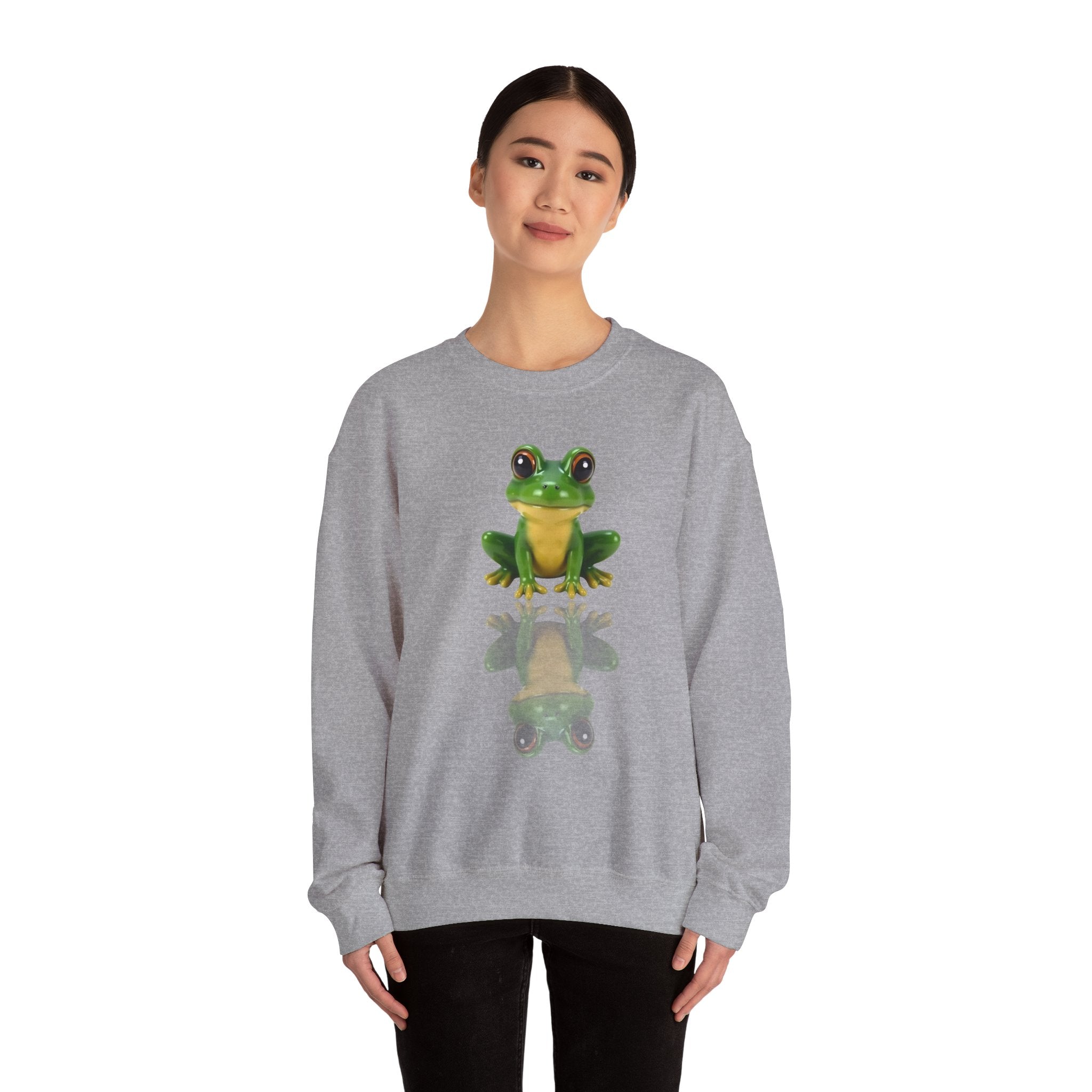 Person wearing a gray sweatshirt with a green frog graphic on a white background