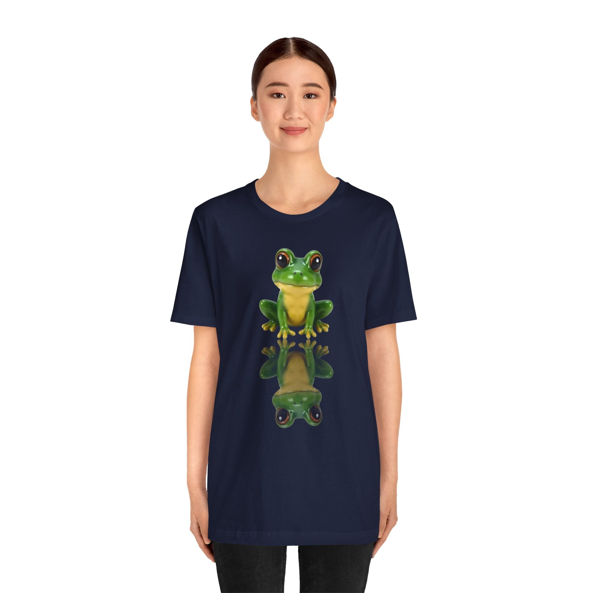 Person wearing a navy blue t-shirt with a green frog graphic on a white background