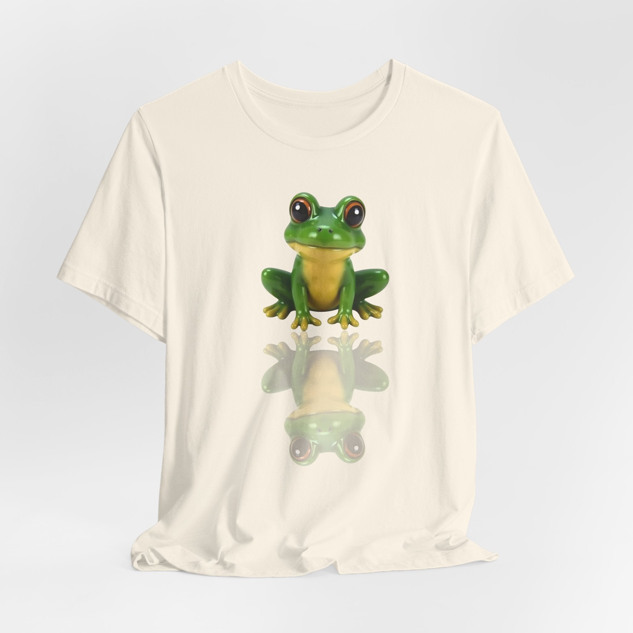 Ivory beige t-shirt with a green frog graphic on a light gray background