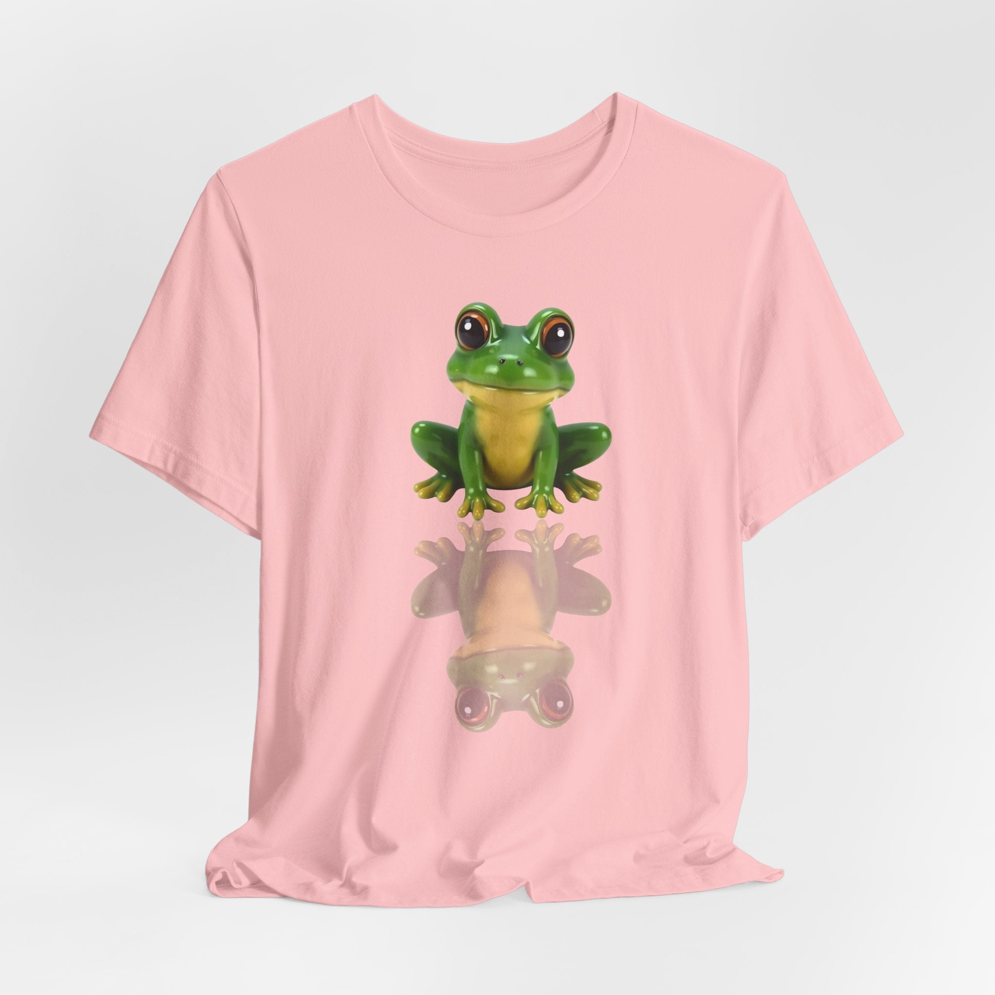Pink t-shirt with a green frog graphic on a light gray background