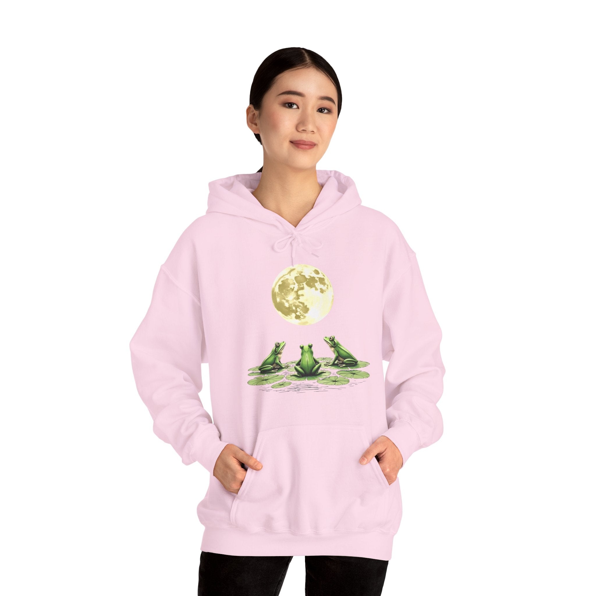 Person wearing a pink hoodie with frog design on a white background