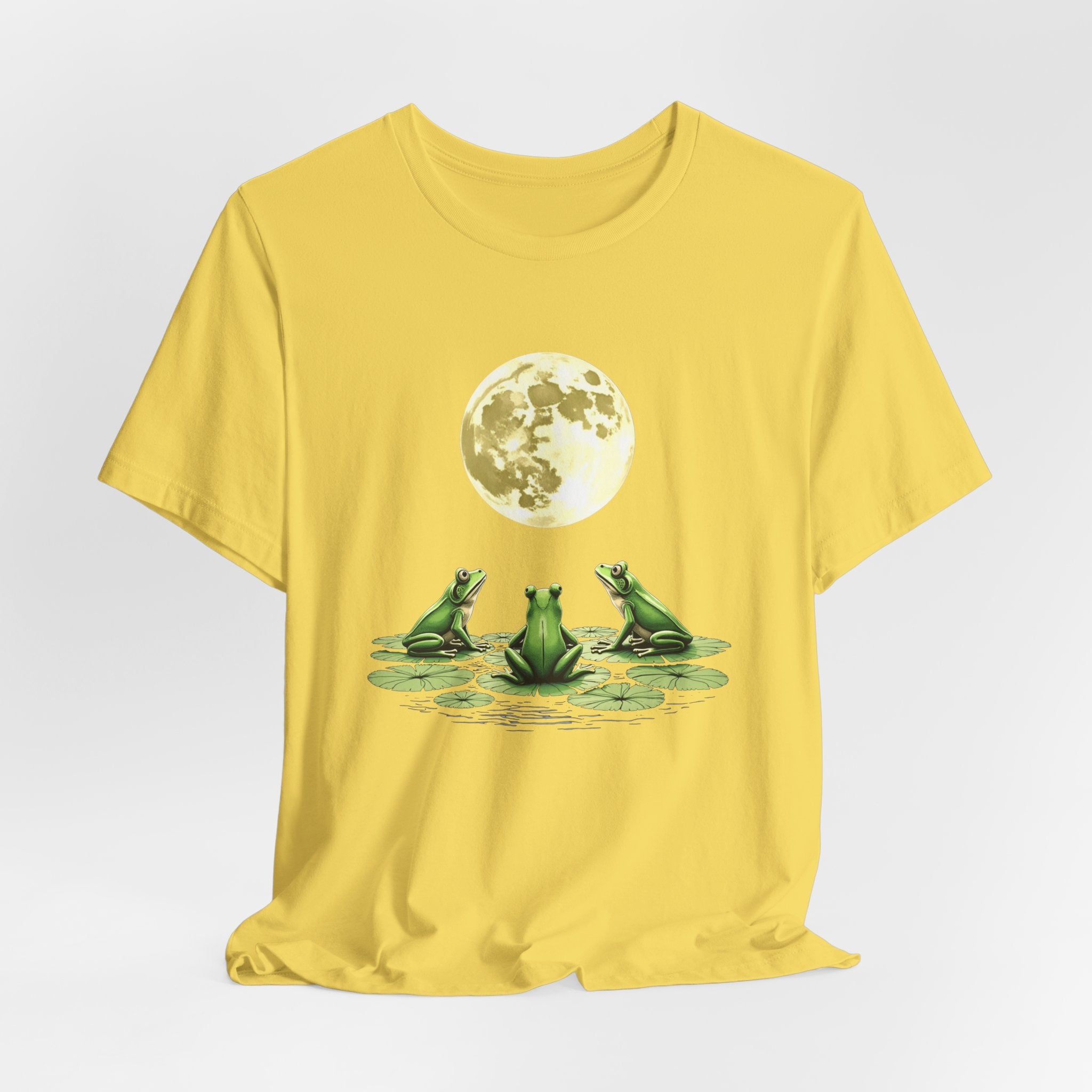Maze yellow t-shirt featuring cute frogs sitting on top of water lily watching on the moon graphic on a white background