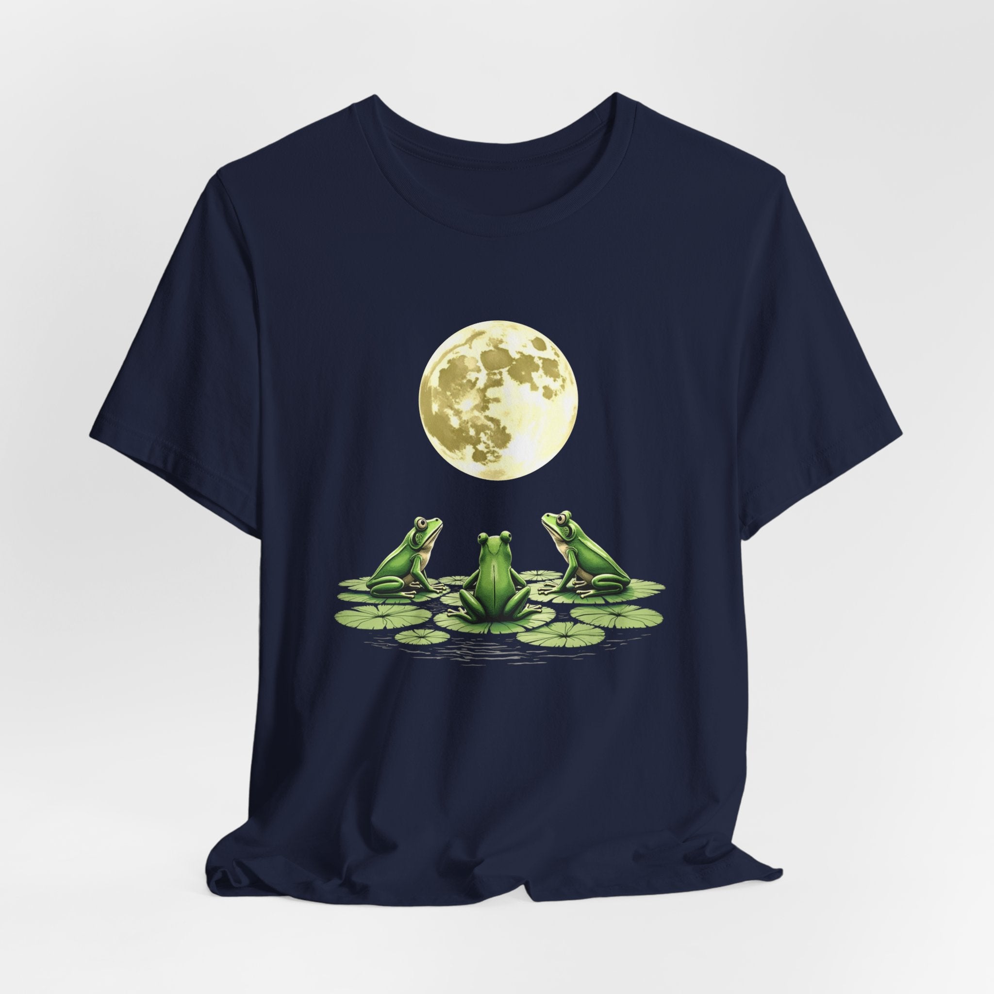 Navy blue t-shirt featuring cute frogs sitting on top of water lily watching on the moon graphic on a white background