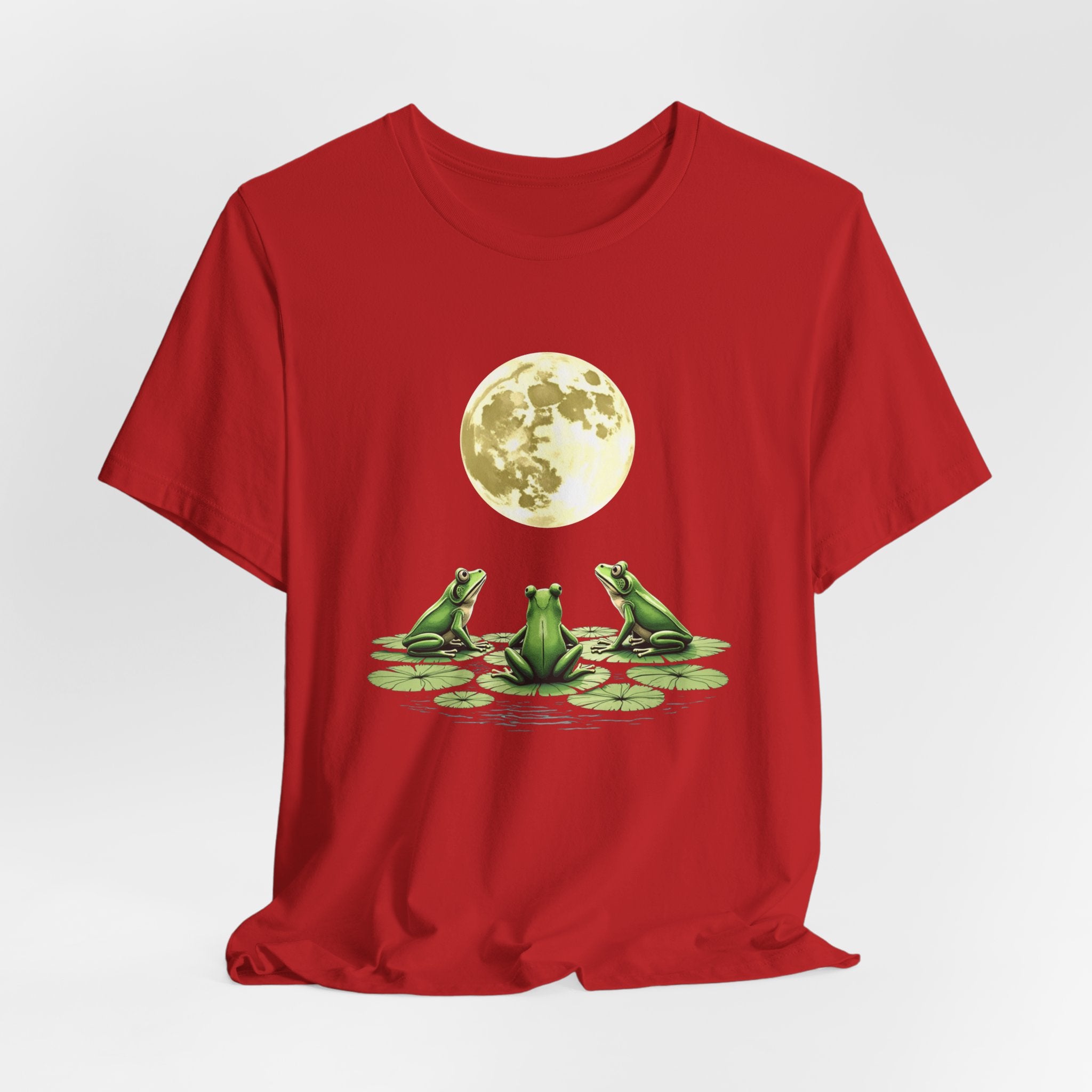 Red t-shirt featuring cute frogs sitting on top of water lily watching on the moon graphic on a white background