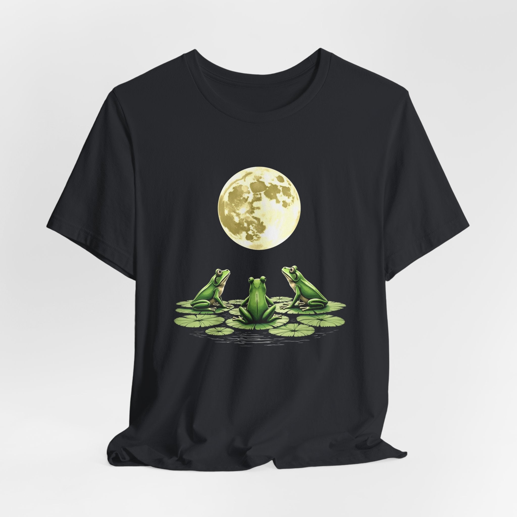 Vintage black t-shirt featuring cute frogs sitting on top of water lily watching on the moon graphic on a white background